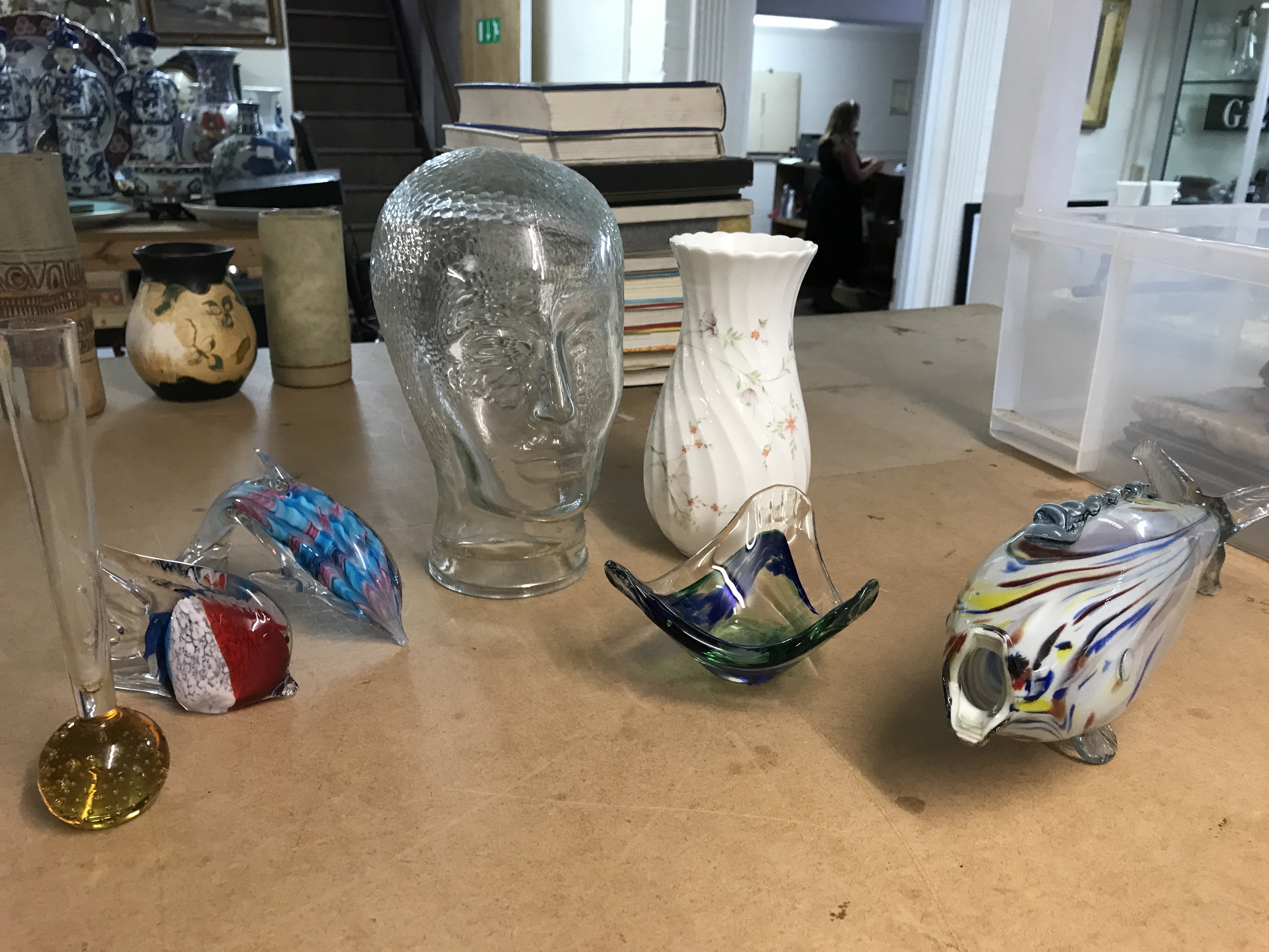 A Collection of ceramics including a glass head, Wedgwood vase and fish figures . This lot cannot be posted