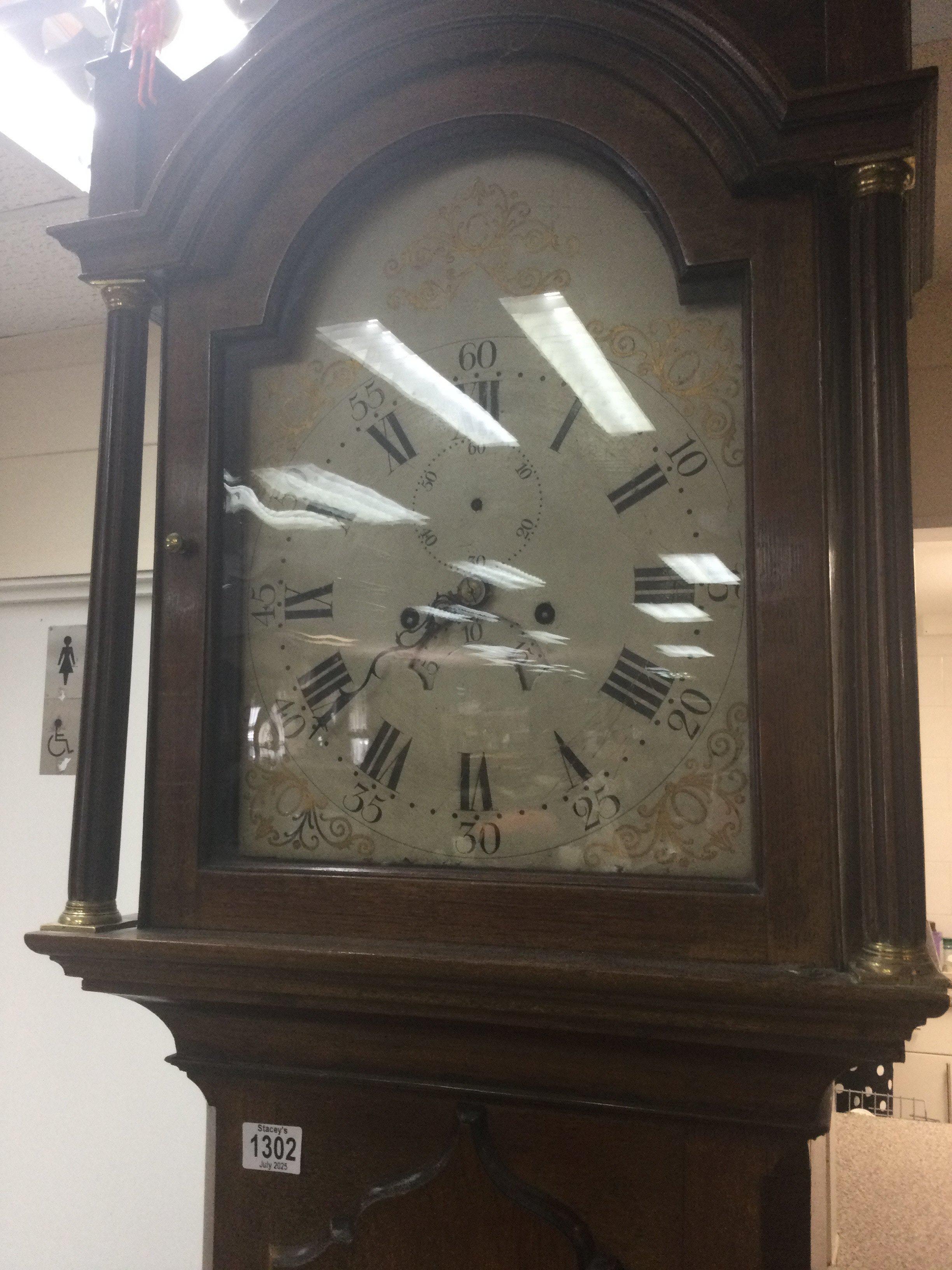 A mahogany long case the painted dial with Roman numerals.