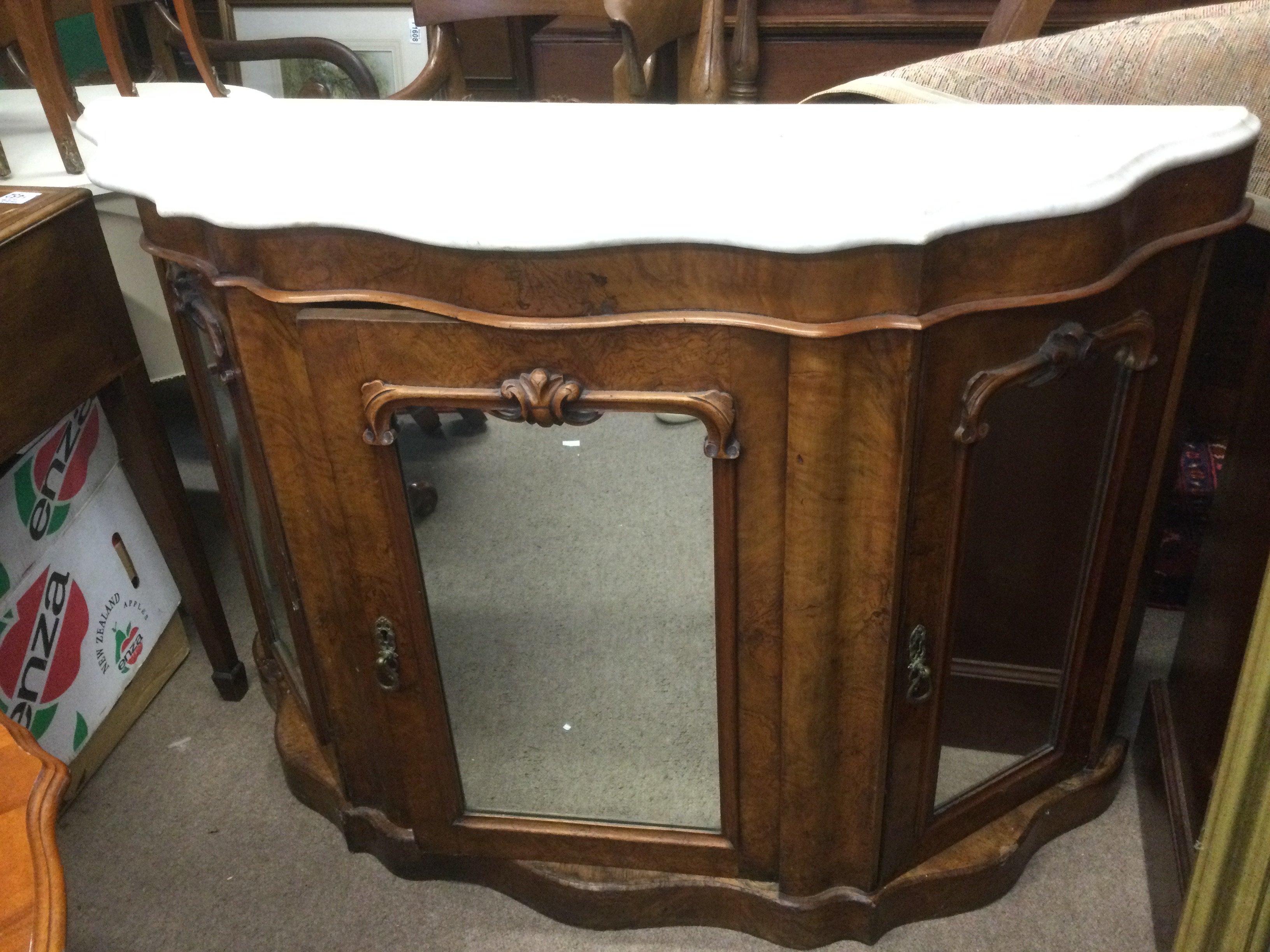 A Victorian walnut marble topped credenza with mirrored doors, approx 121cm x 37cm x 85cm. Shipping category D.