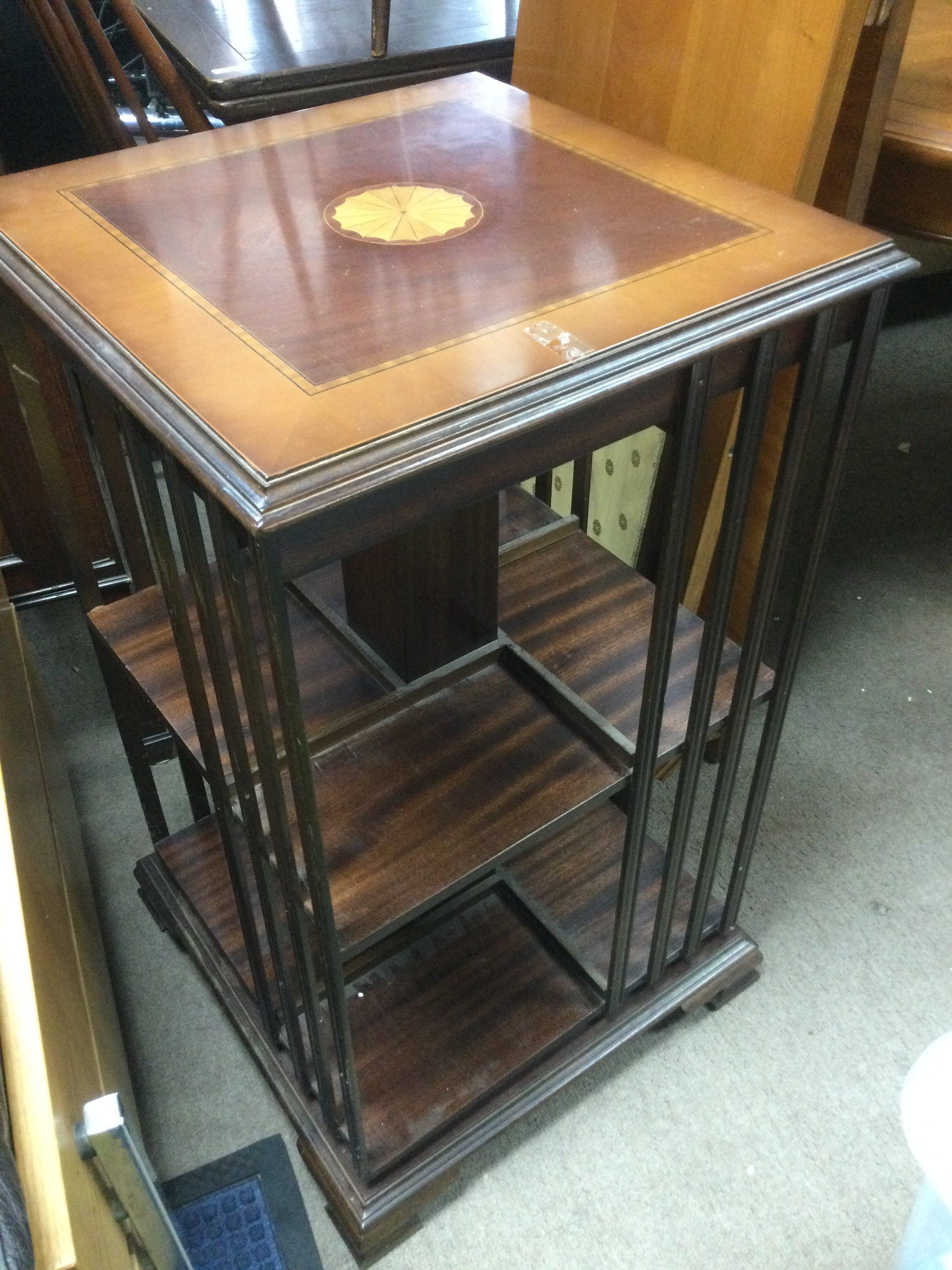 An inlaid mahogany revolving bookcase. Shipping category D.