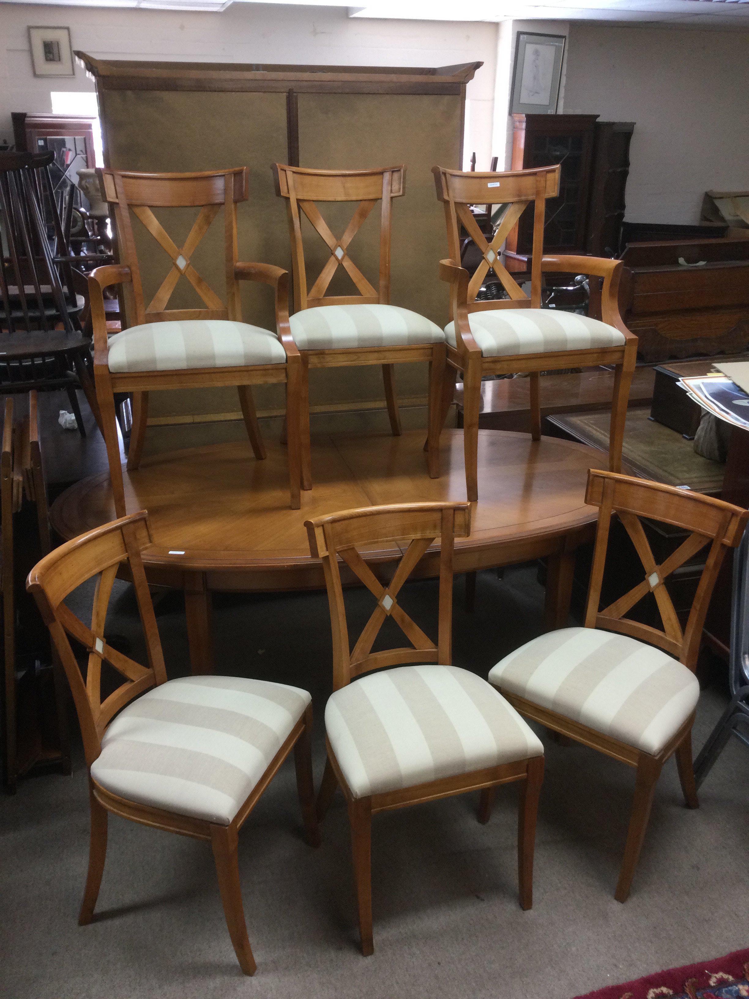 A bespoke cherry wood extending dining table with two carvers and four chairs.Approx 185cm x 105cm when closed. Shipping category D.
