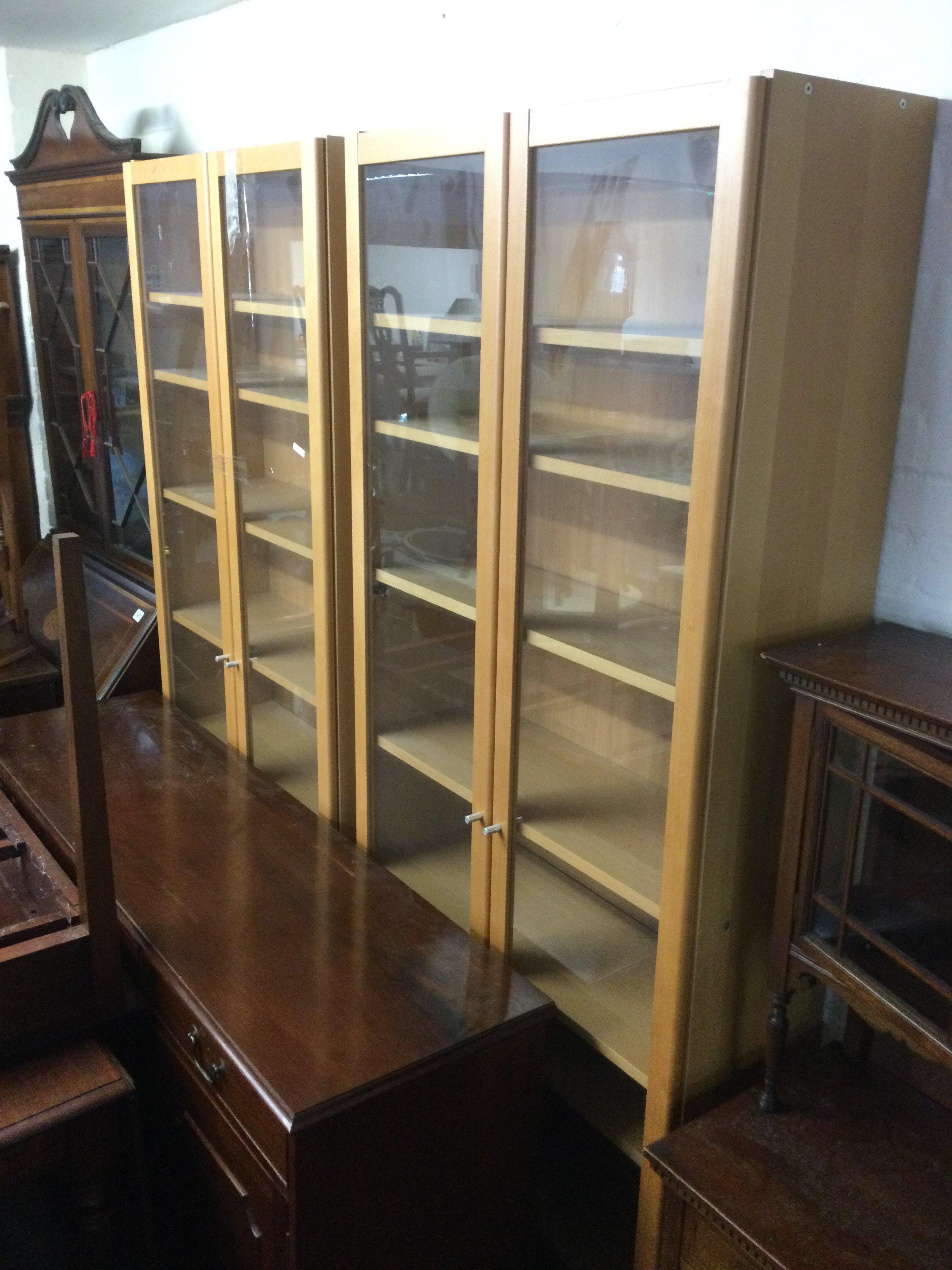 Two light wood display cabinets, approx height 202cm. Shipping category D.