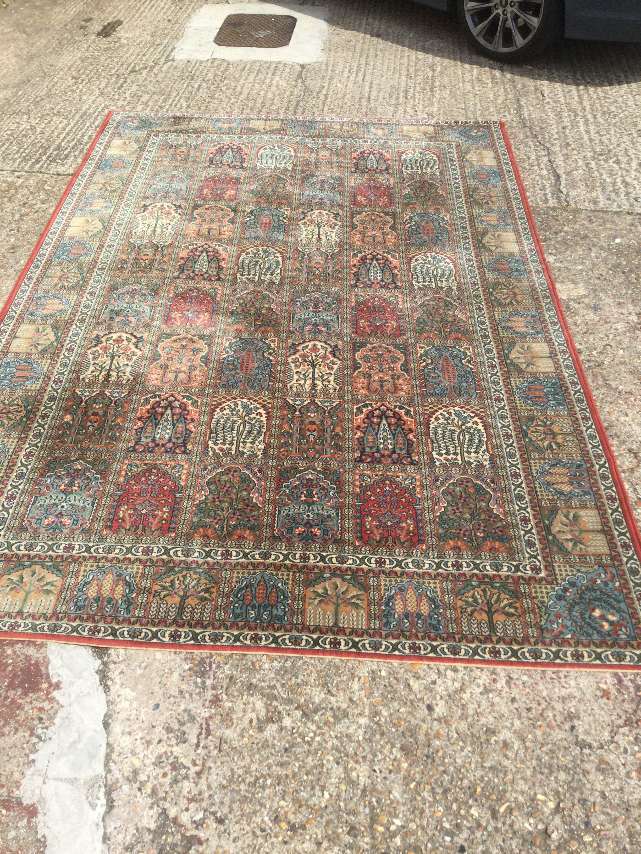 A modern rug in Persian garden pattern, approx 304cm x 200cm. Shipping category D.