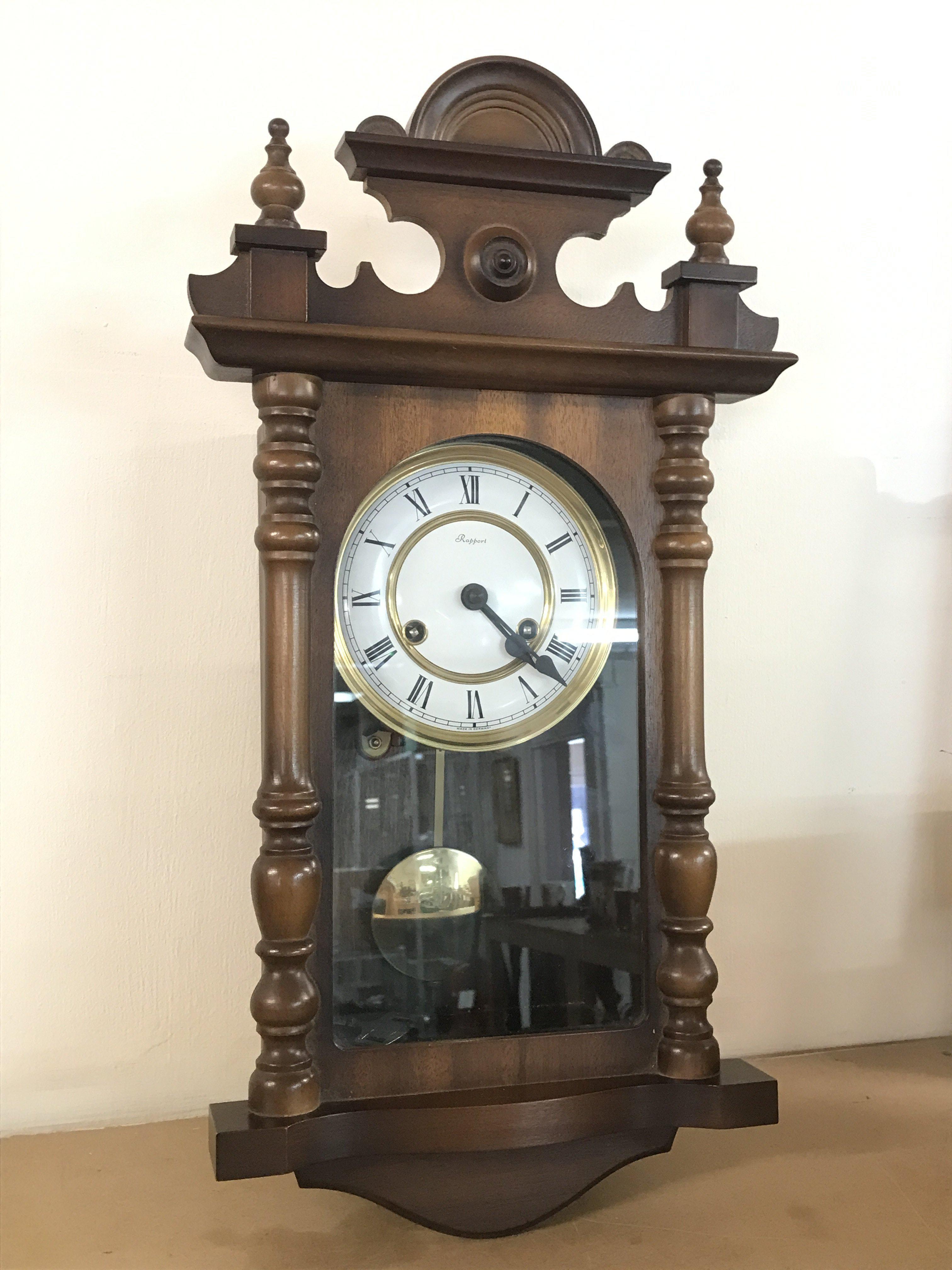 A German Rapport Wall clock with key and pendulum , 23cm tall approximately. This lot cannot be posted