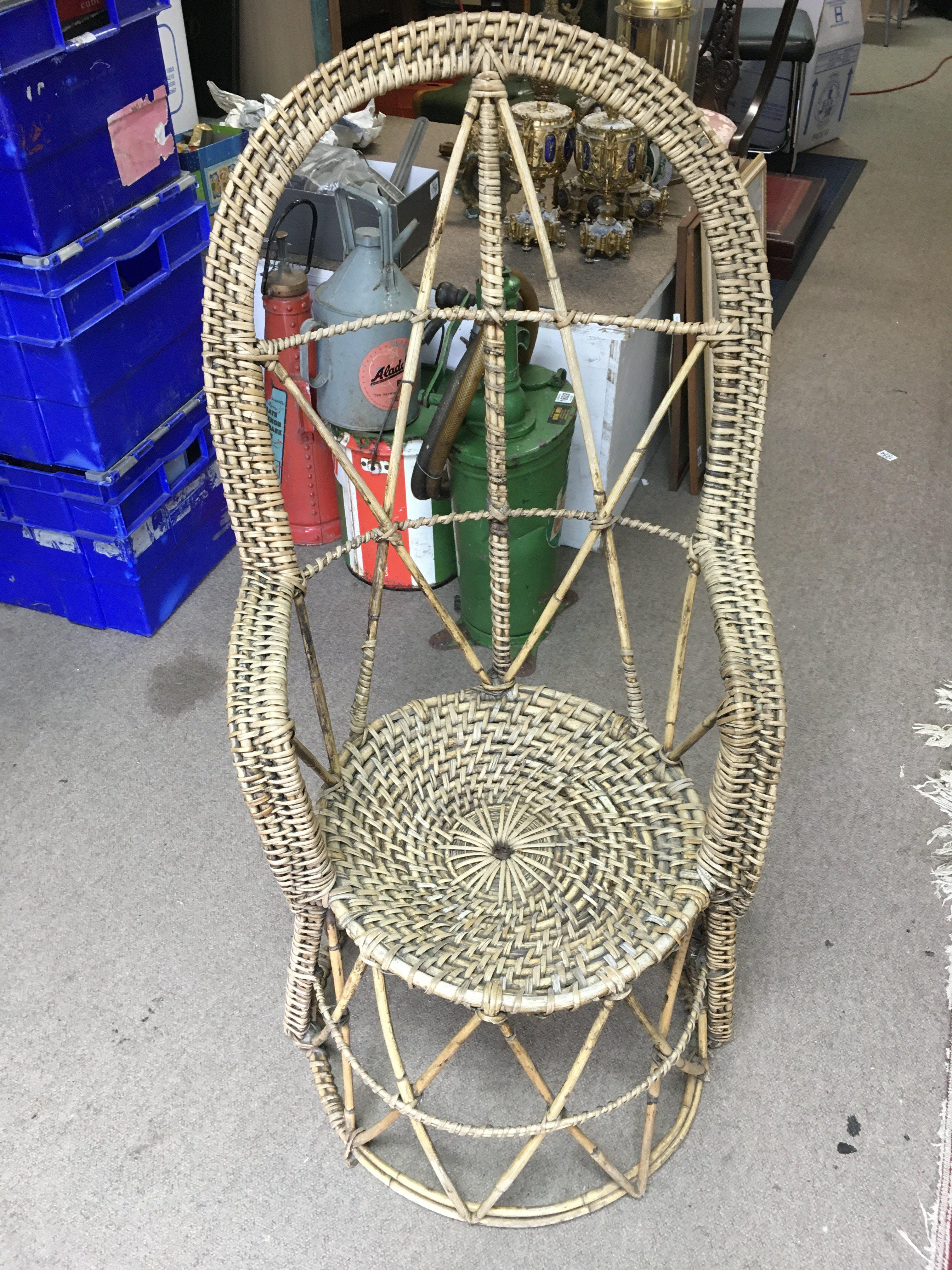 A vintage Rattan cane conservatory chair , dimensions 104cm tall 51cm wide