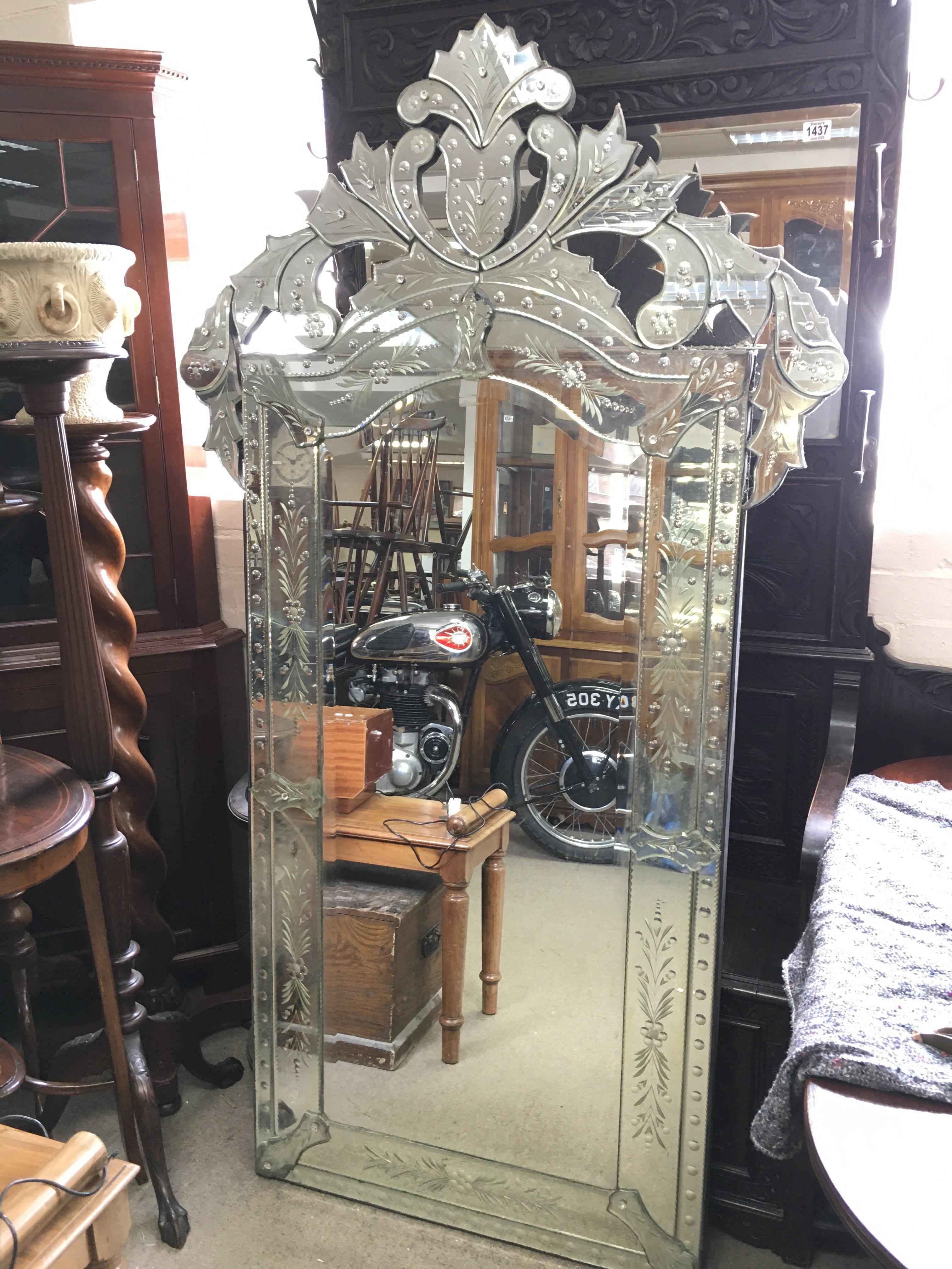 A large Venetian mirror , dimensions 97cm wide 179cm tall
