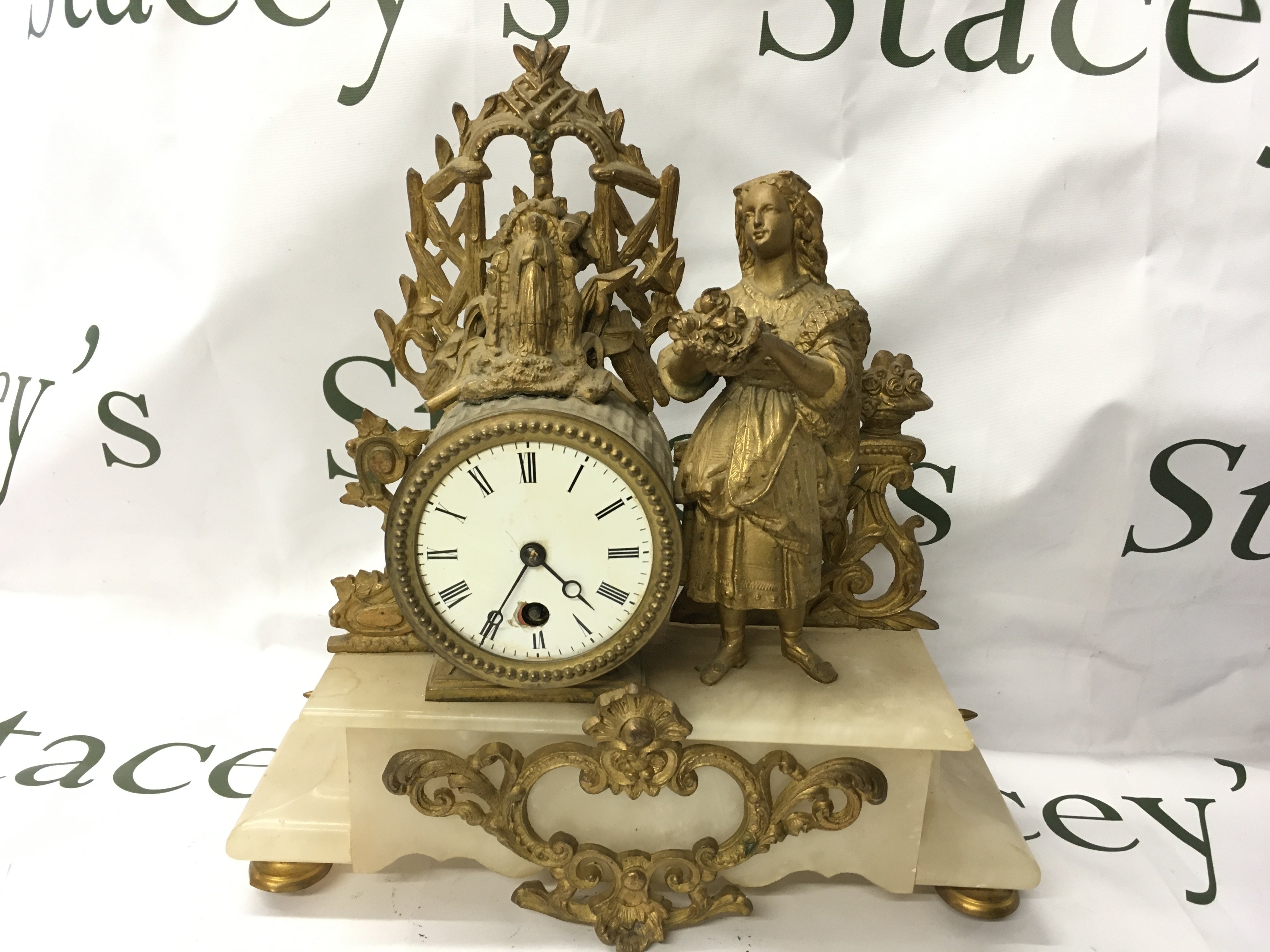 A French Gilt marble clock. This lot cannot be posted