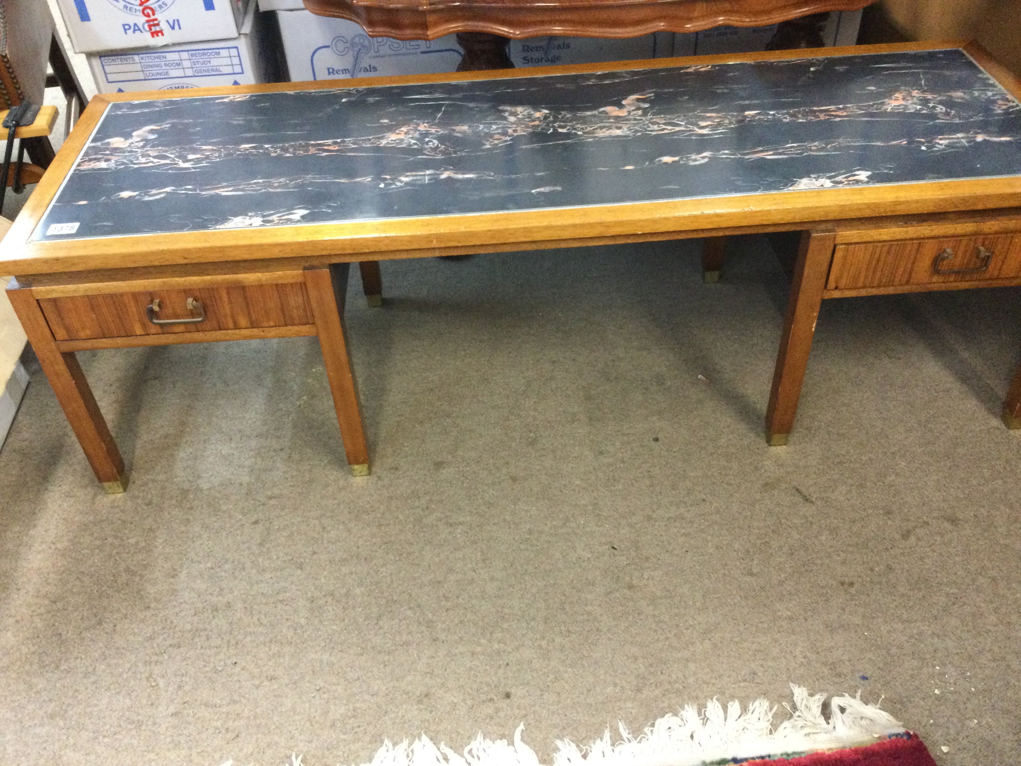 A g plan low occasional table the rectangular top with simulated marble top above two drawers on square tapering leg .