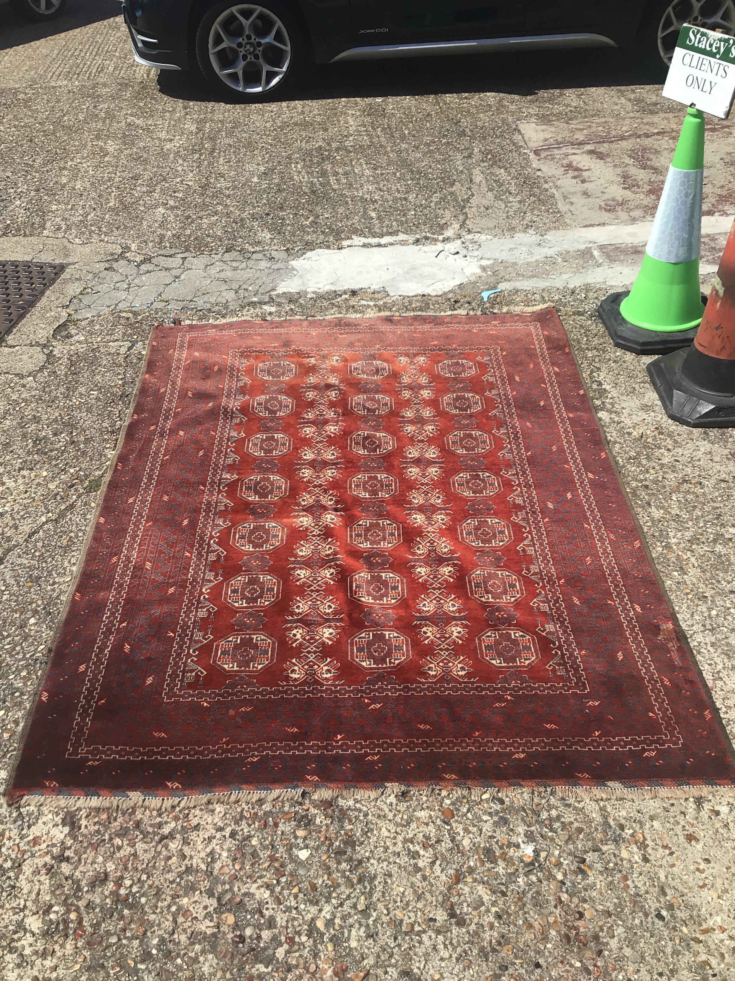 An Afghan/ tribal rug 148cm wide , 202cm long