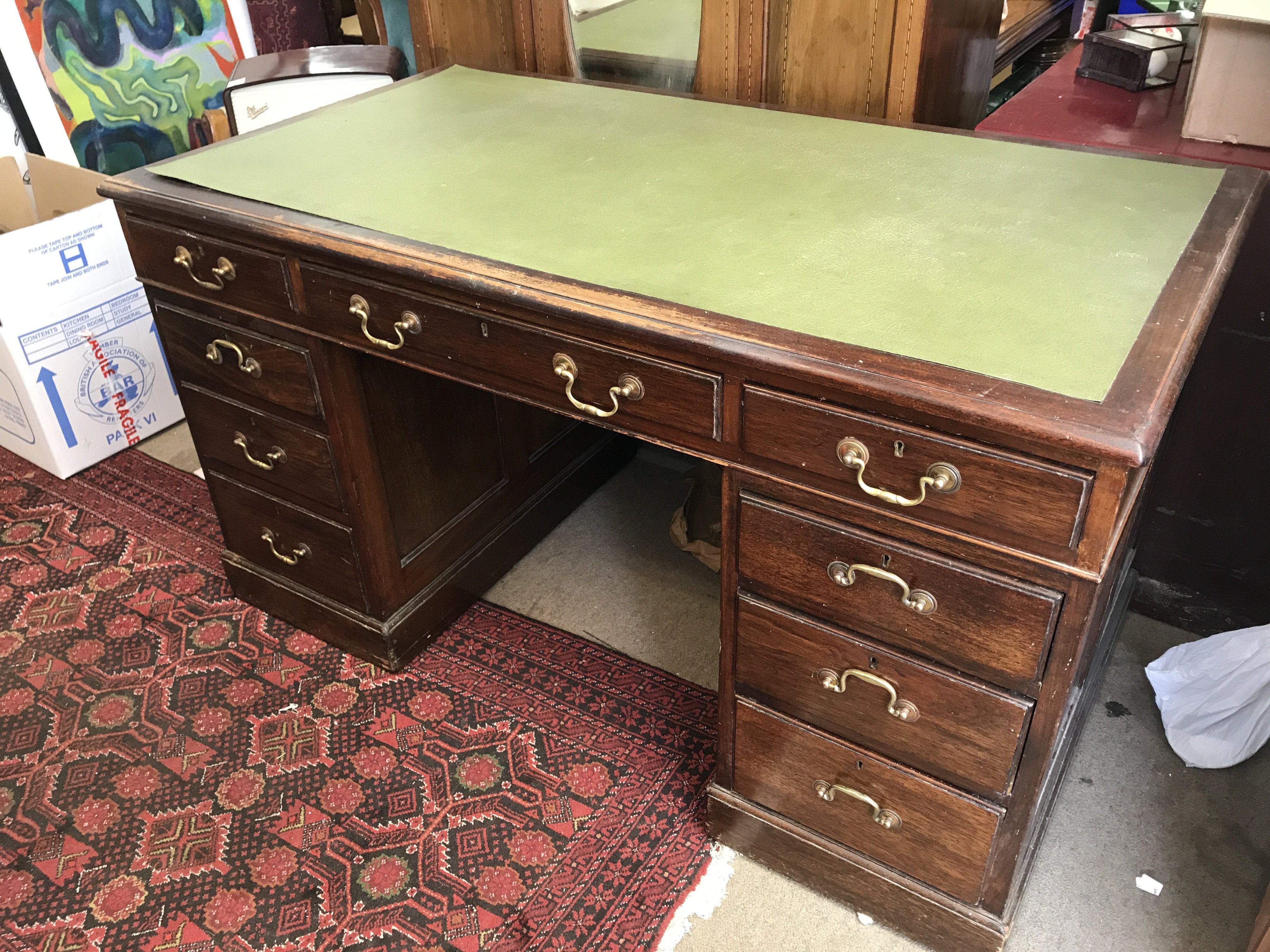 A three piece oak pedestal writing desk, 135cm wide 77cm tall.