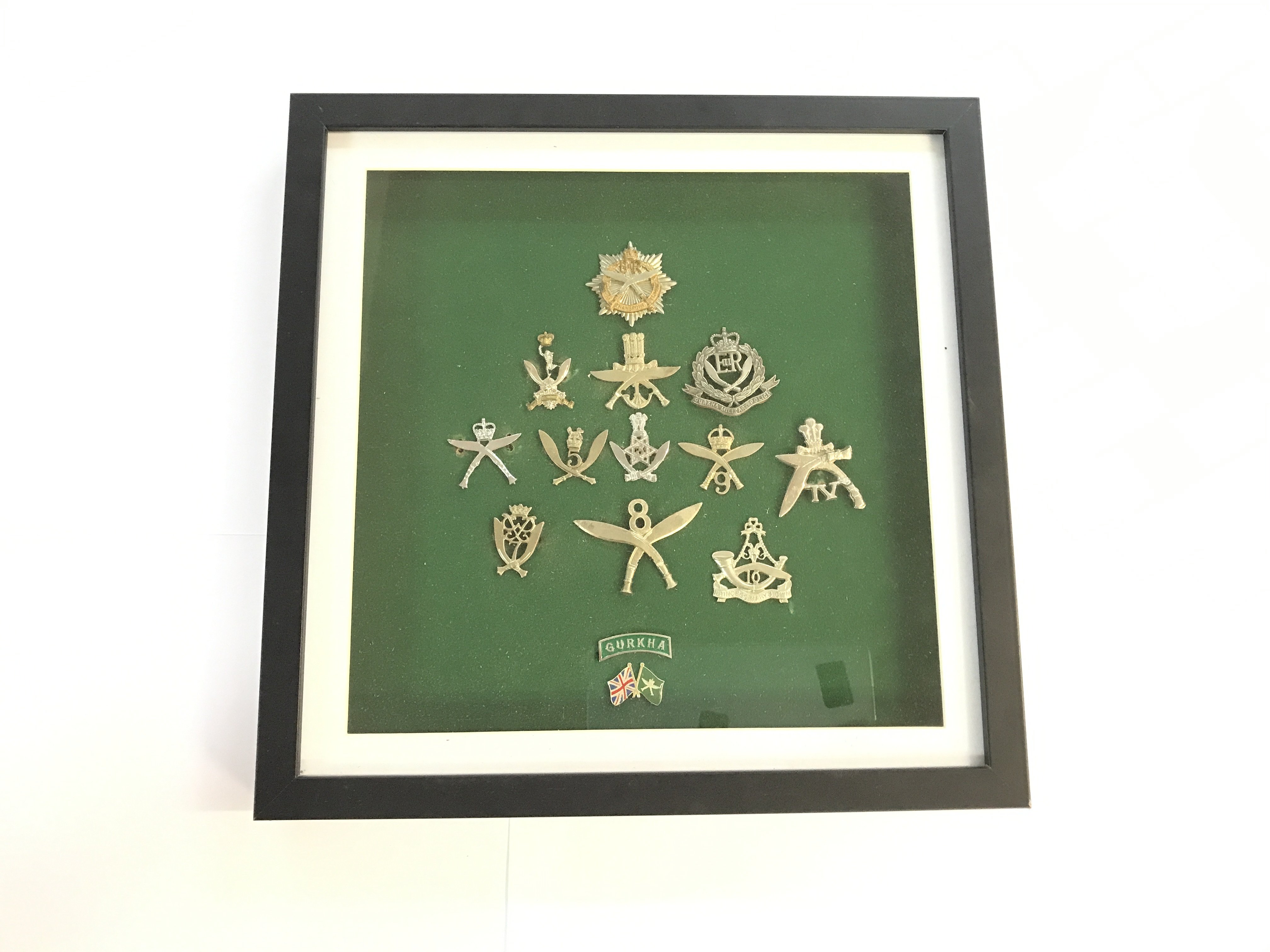 2 cased military collections. One case includes a series of Gurkha British army unit medals, the other includes a wide variety of British army uniform buttons.