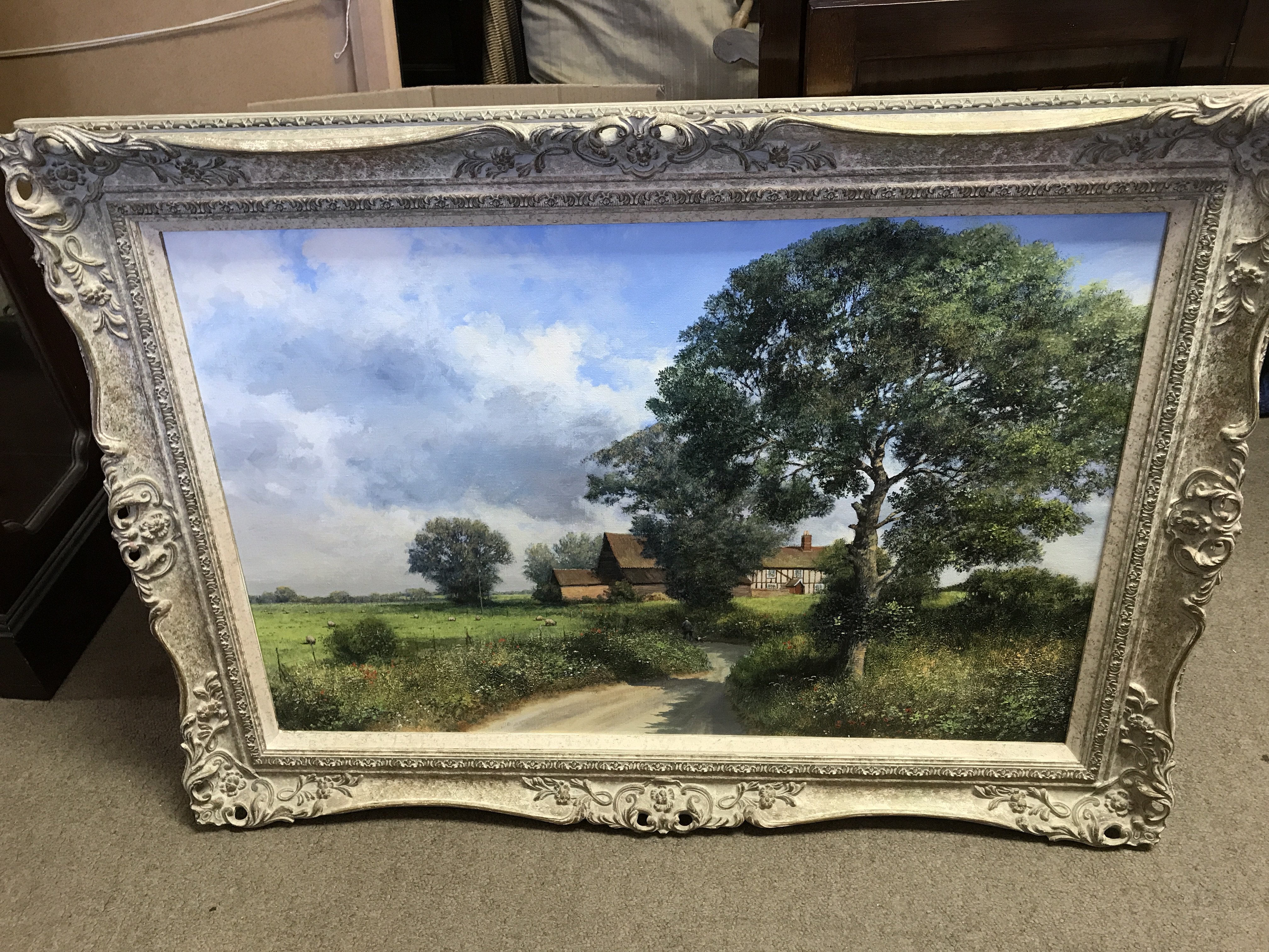 A framed oil painting of a rural landscape by Clive Madgwick (1934-2005) Frame dimensions 92x66cm