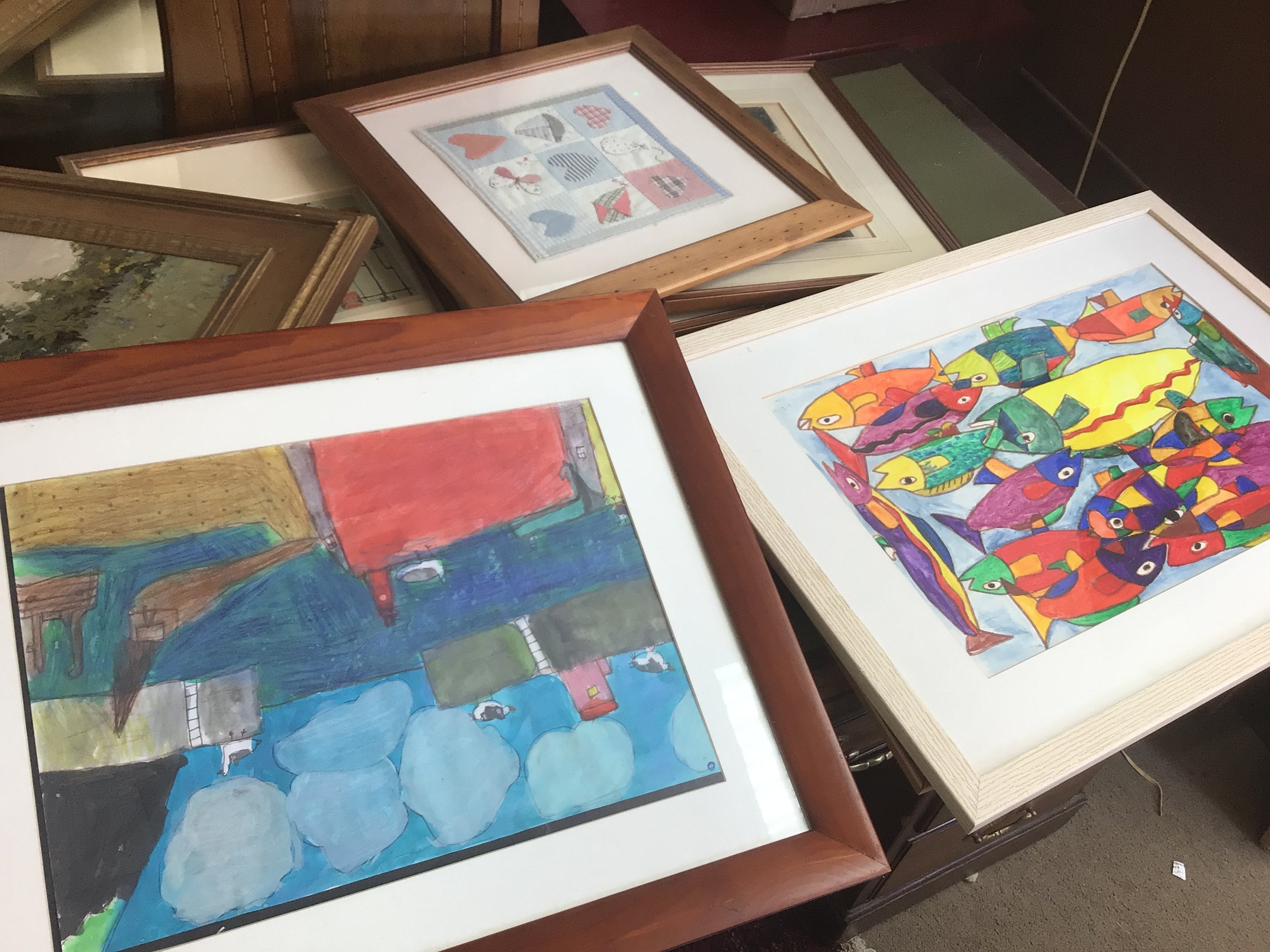 A collection of framed prints including abstract, town scenes etc