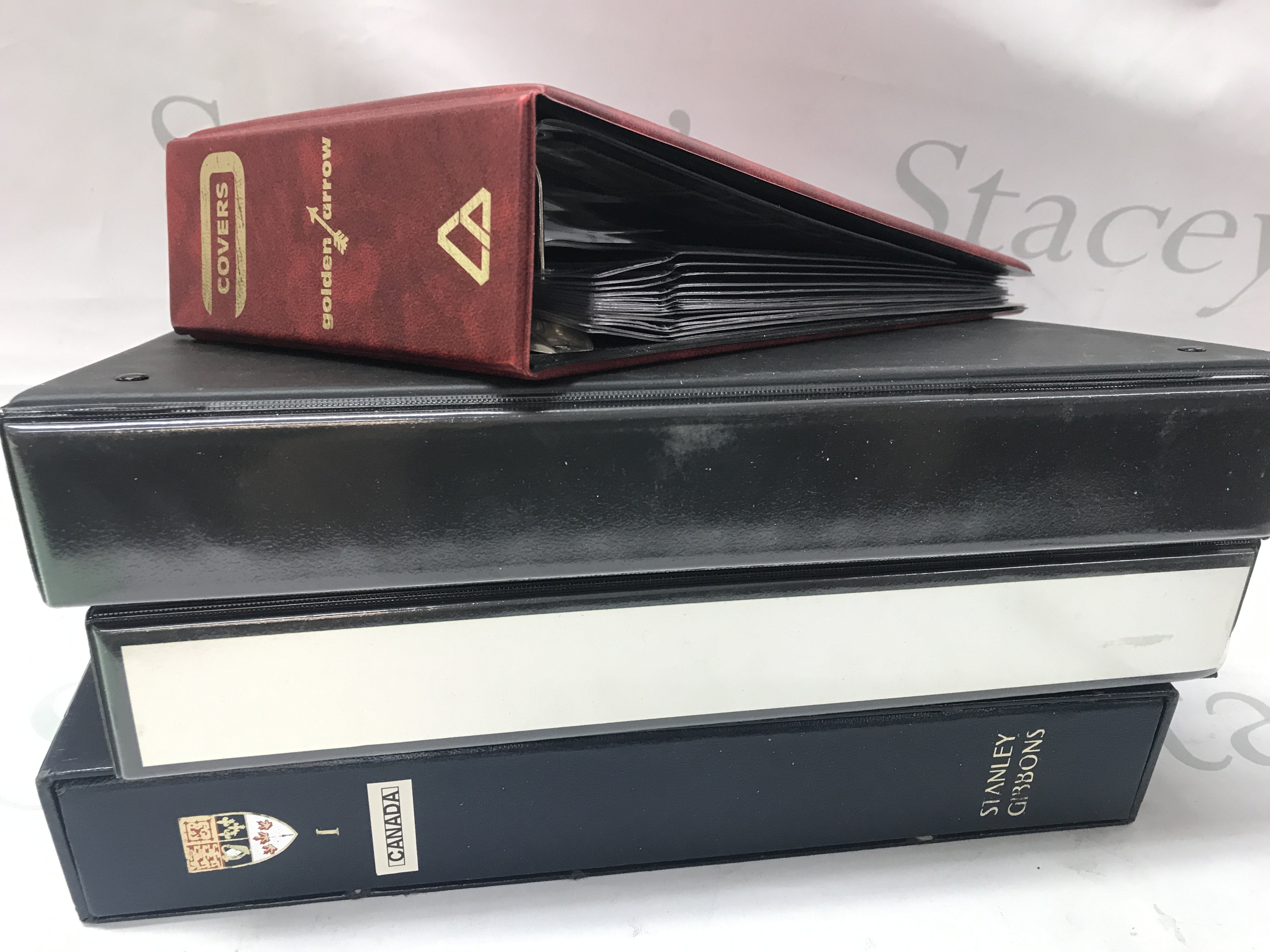 Four stamp albums containing British , Canadian and Commonwealth stamps. Mint and used. Postage category C