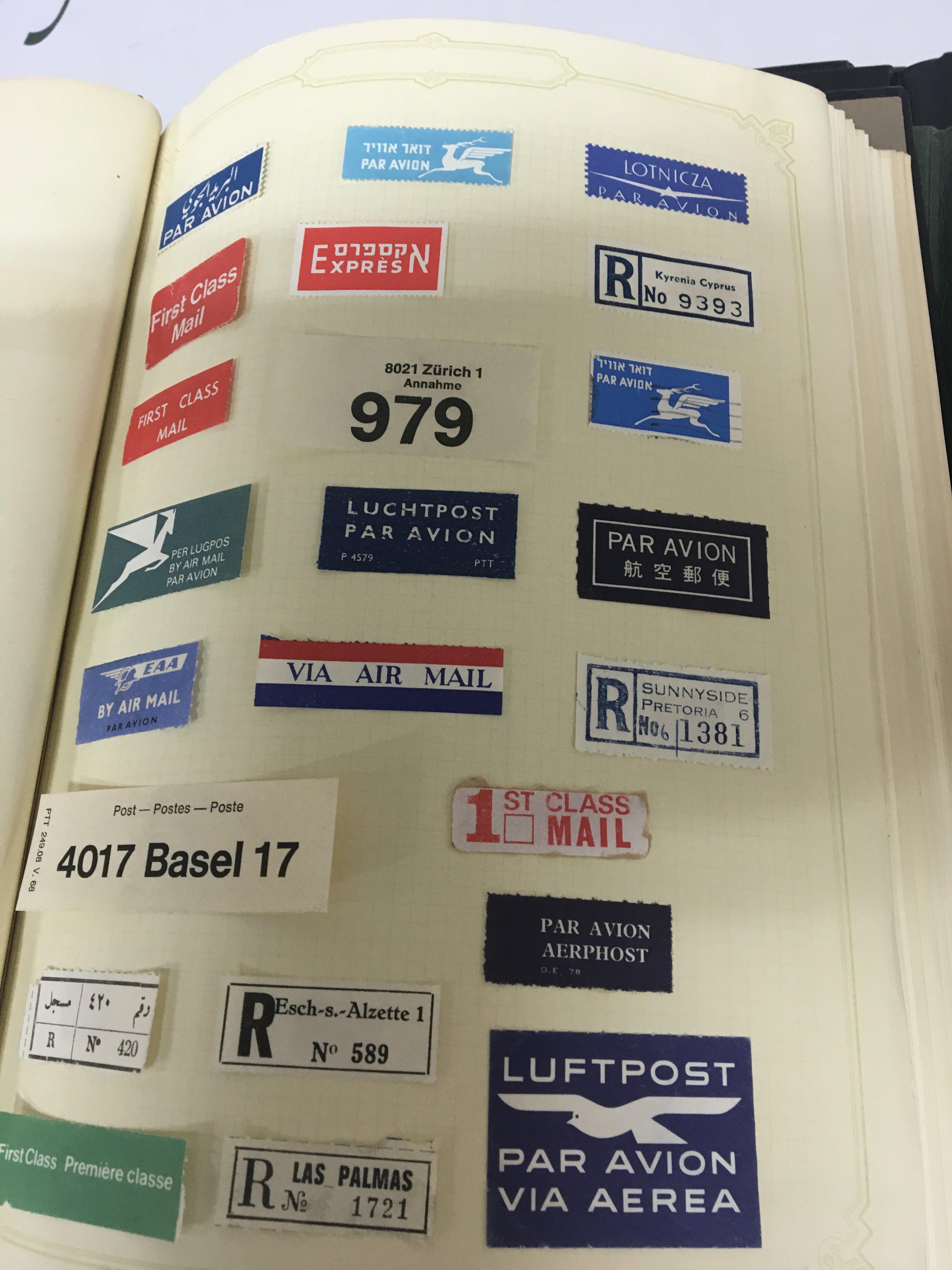 A collection eight of world stamp albums including some 19th century stamps Queensland world Express and Airmail postal labels Chanel Island stamps and others (8)