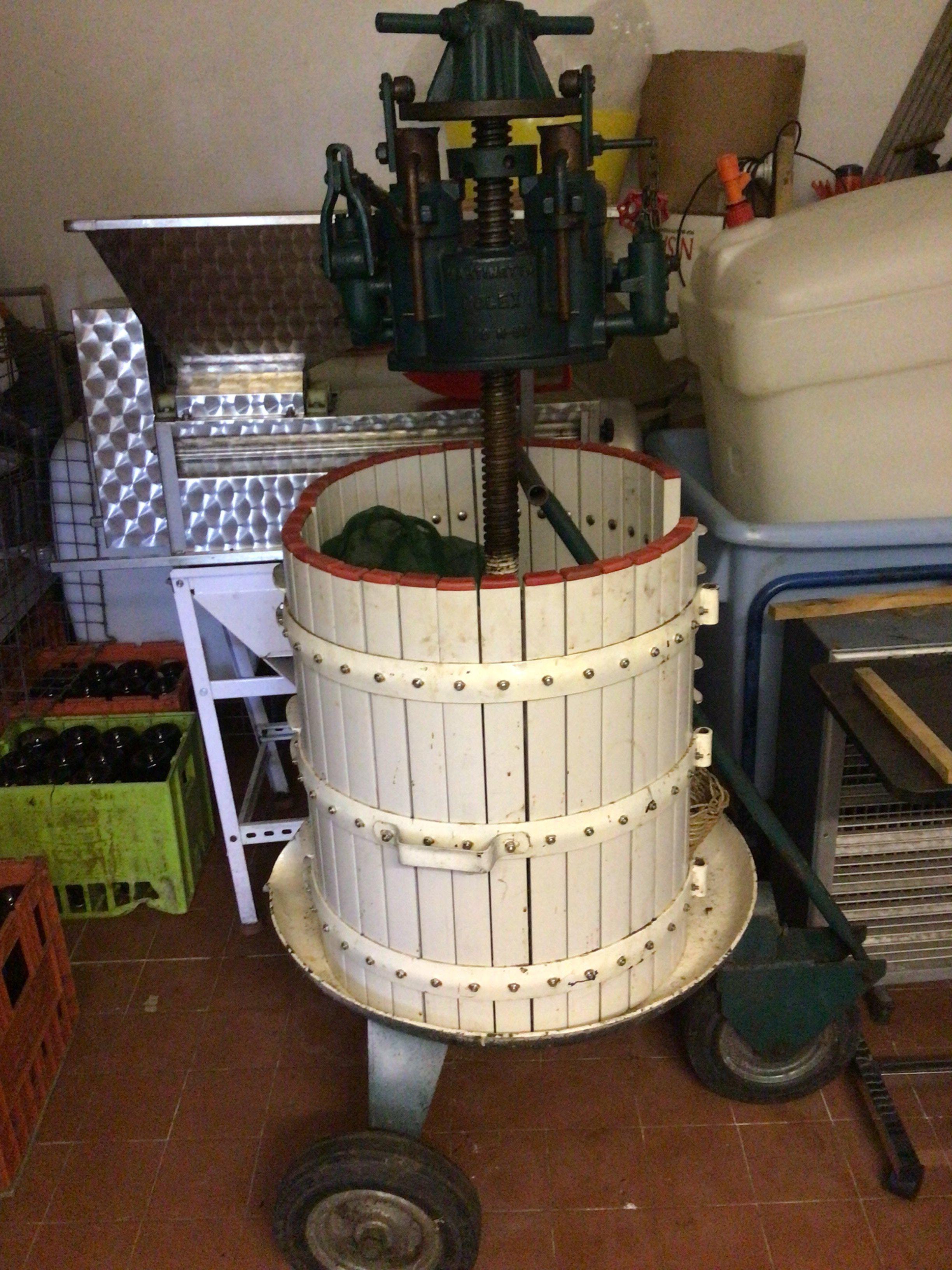 A large Martinetto Rolex Tipo N-50 grape press on a trolley with wheels