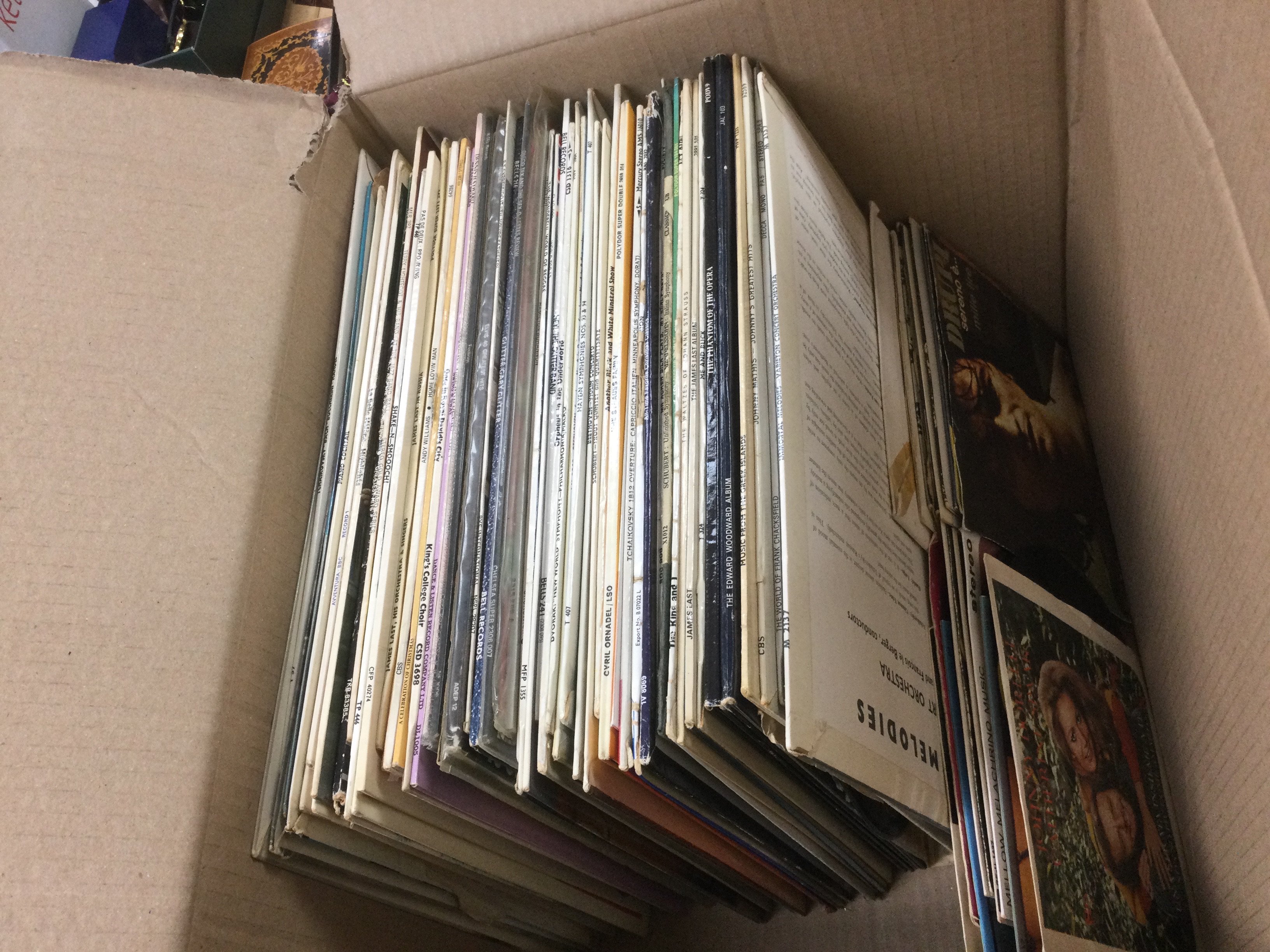A vox of LPs and 7" singles by various artists including Elvis Presley, Ricky Nelson and others.
