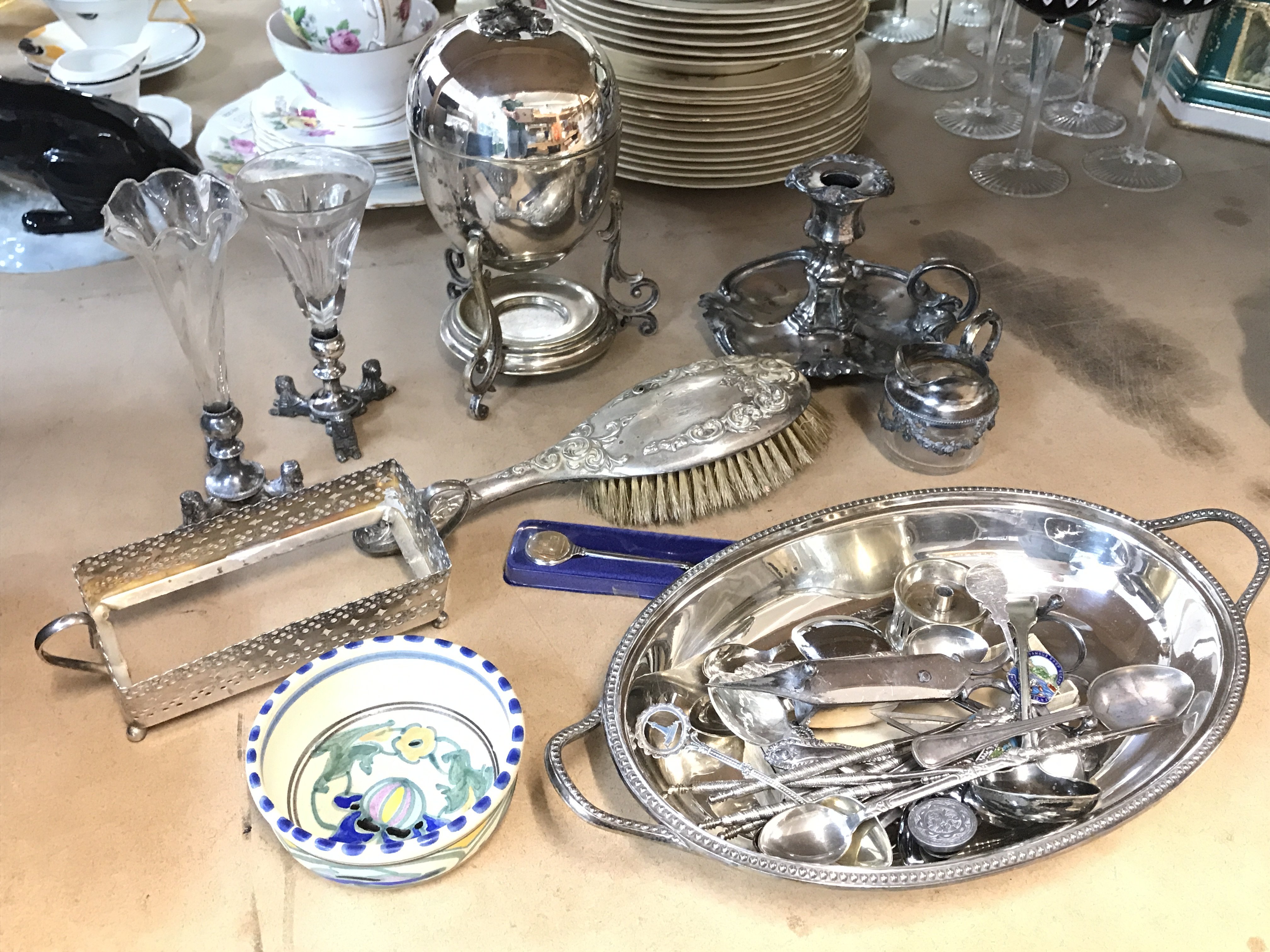 A collection of silver plate including Egyptian style flower vases, Egg Coddler, silver hallmarked hand brush, some silver hallmarked spoons . Postage category C