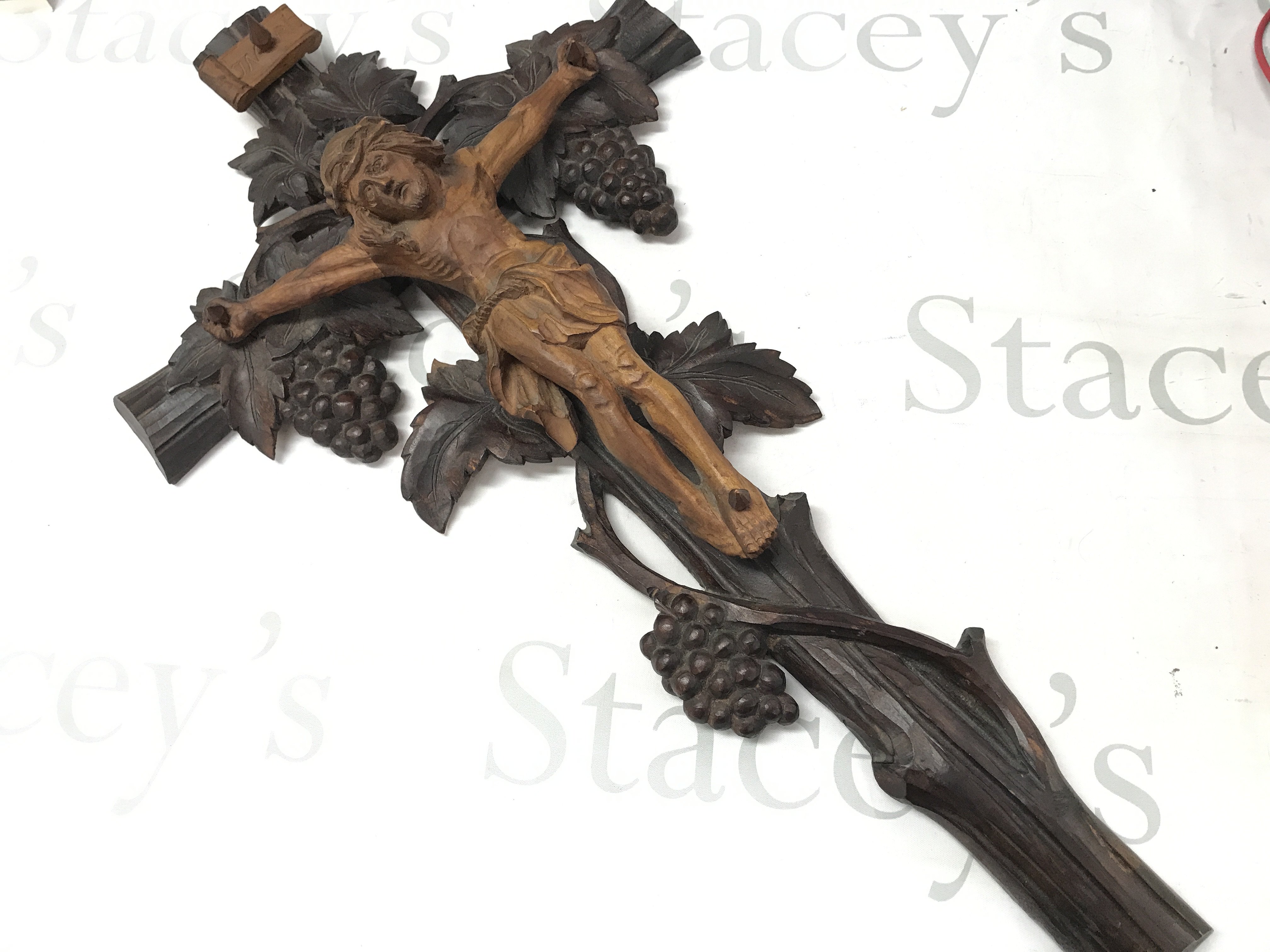 A Black Forest carved crucifix, 64cm tall postage cat B