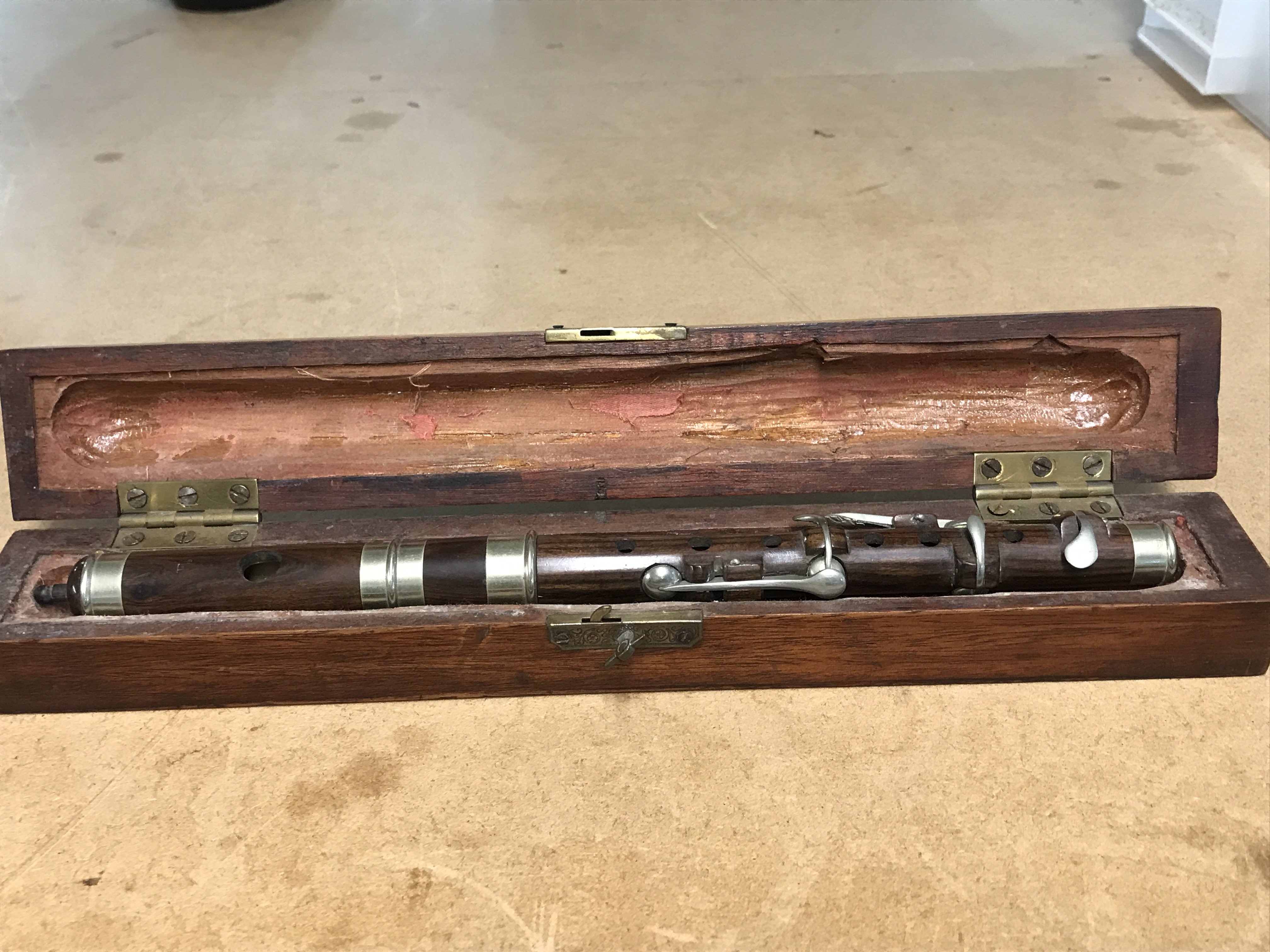 A cased rosewood flute , postage category B