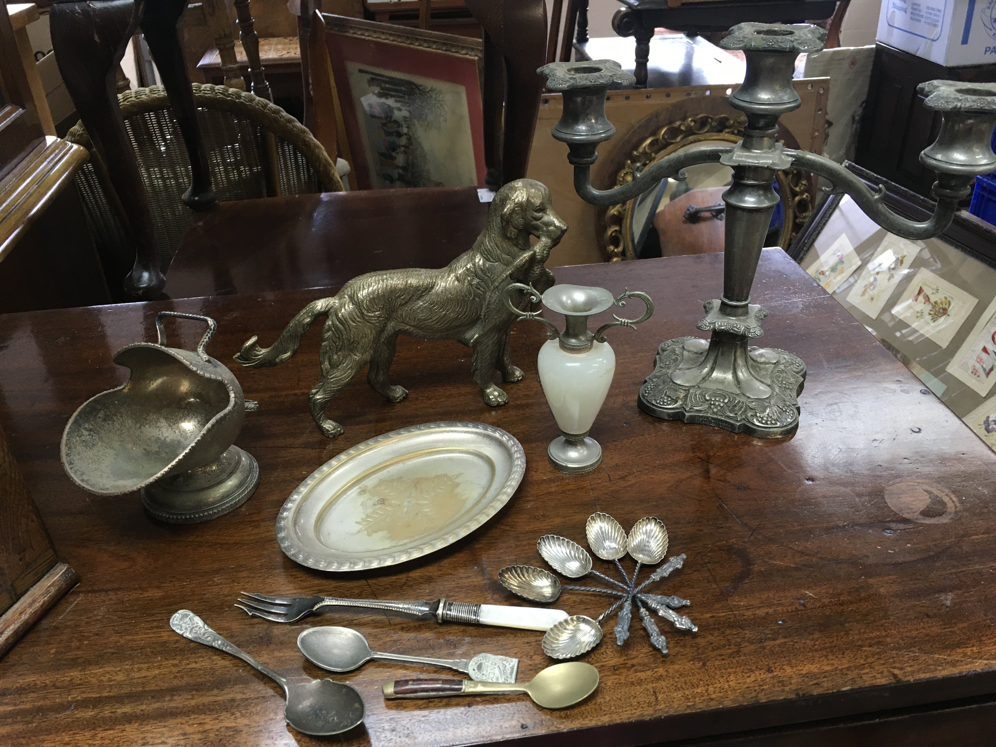 A collection of silver plated items including a hunting dog figure, candelabra, spoons, trophies etc. postage category c. NO RESERVE