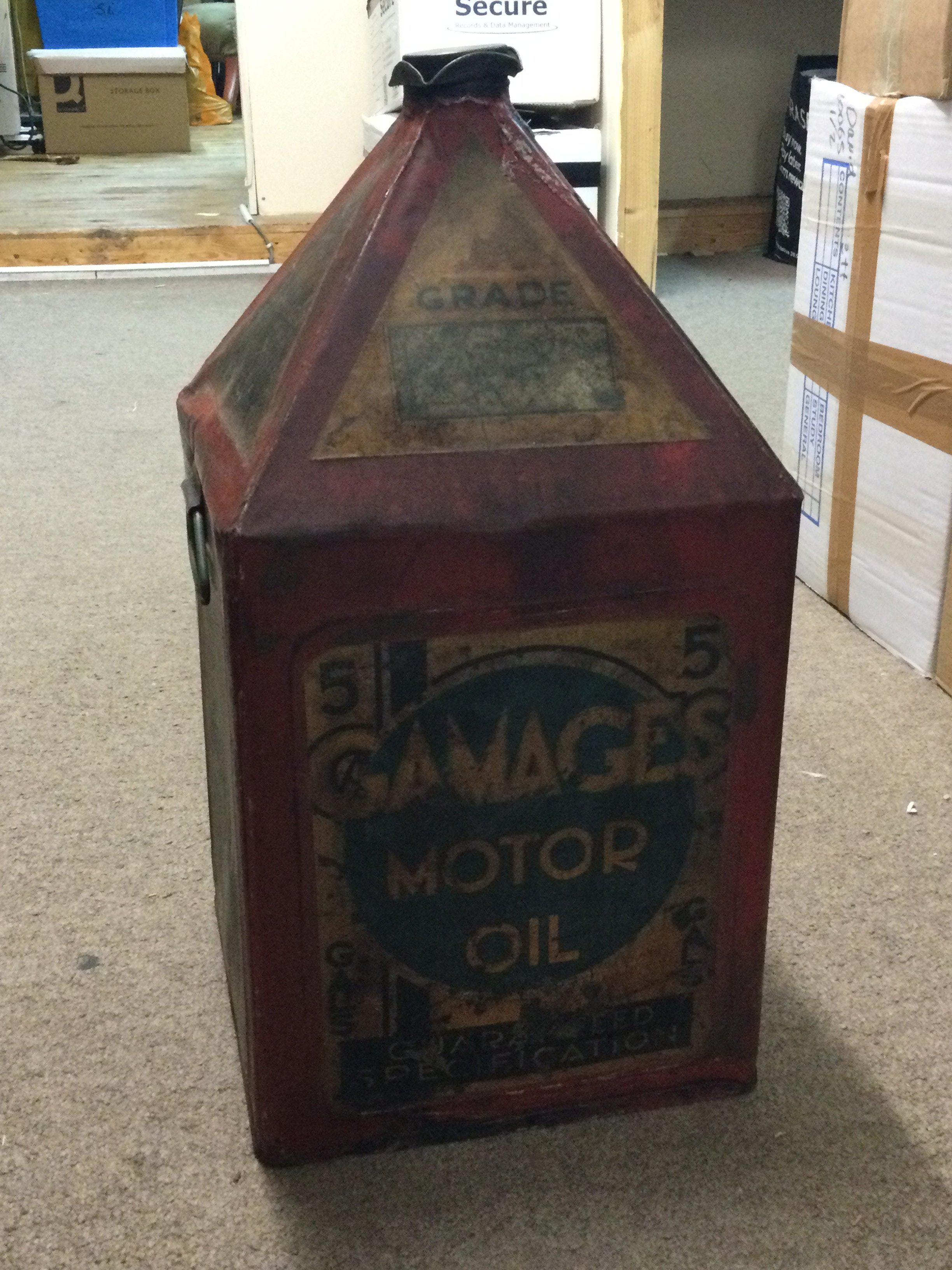 A vintage red pyramid top 5 gallon can advertising Gamages motor oil, 50cm tall . This lot cannot be posted