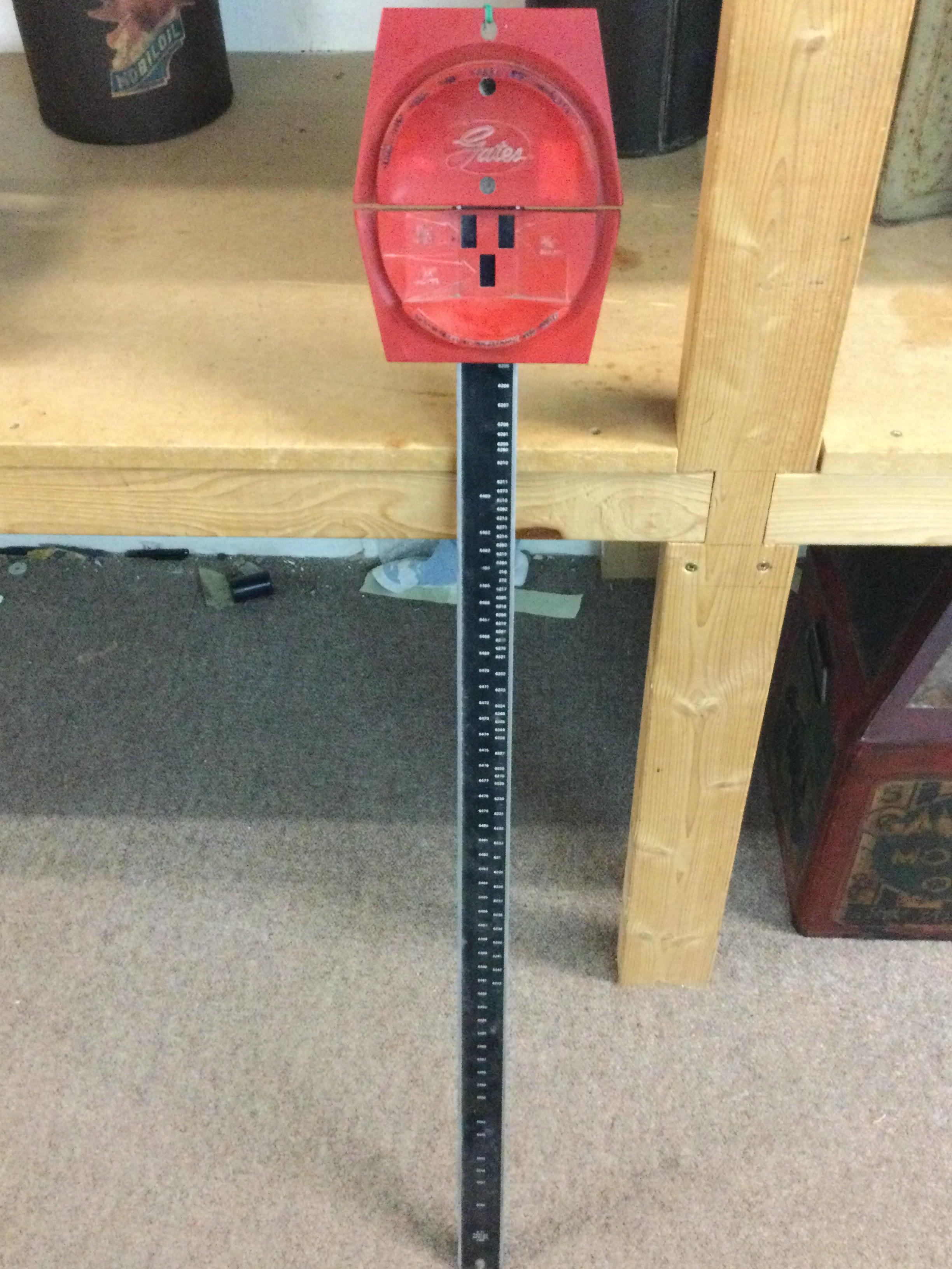 A vintage garage belt measure made by Gates, 98cm tall