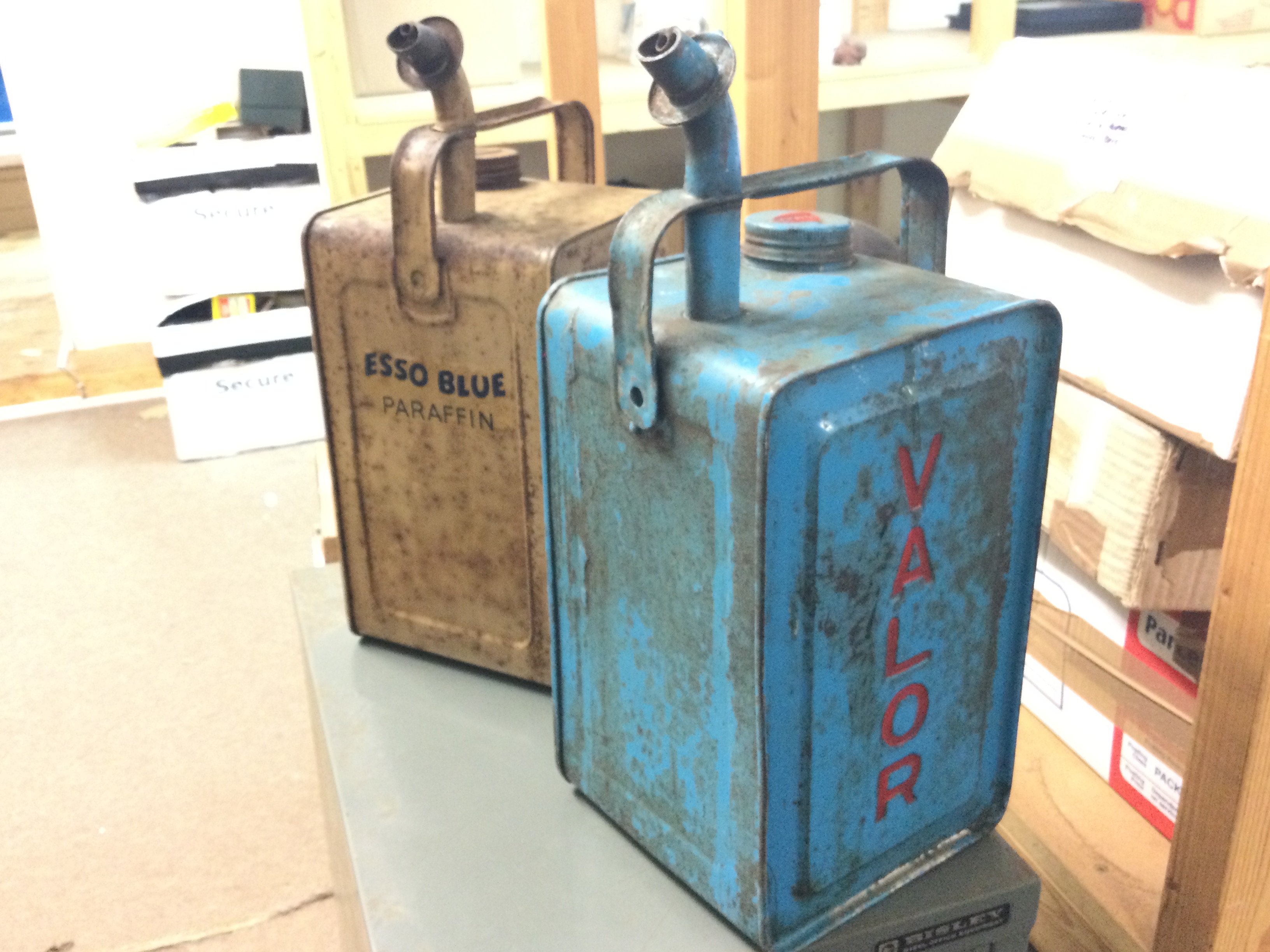 A vintage 1 gallon Esso blue paraffin can and a 1 gallon Valor Paraffin can . Postage category C