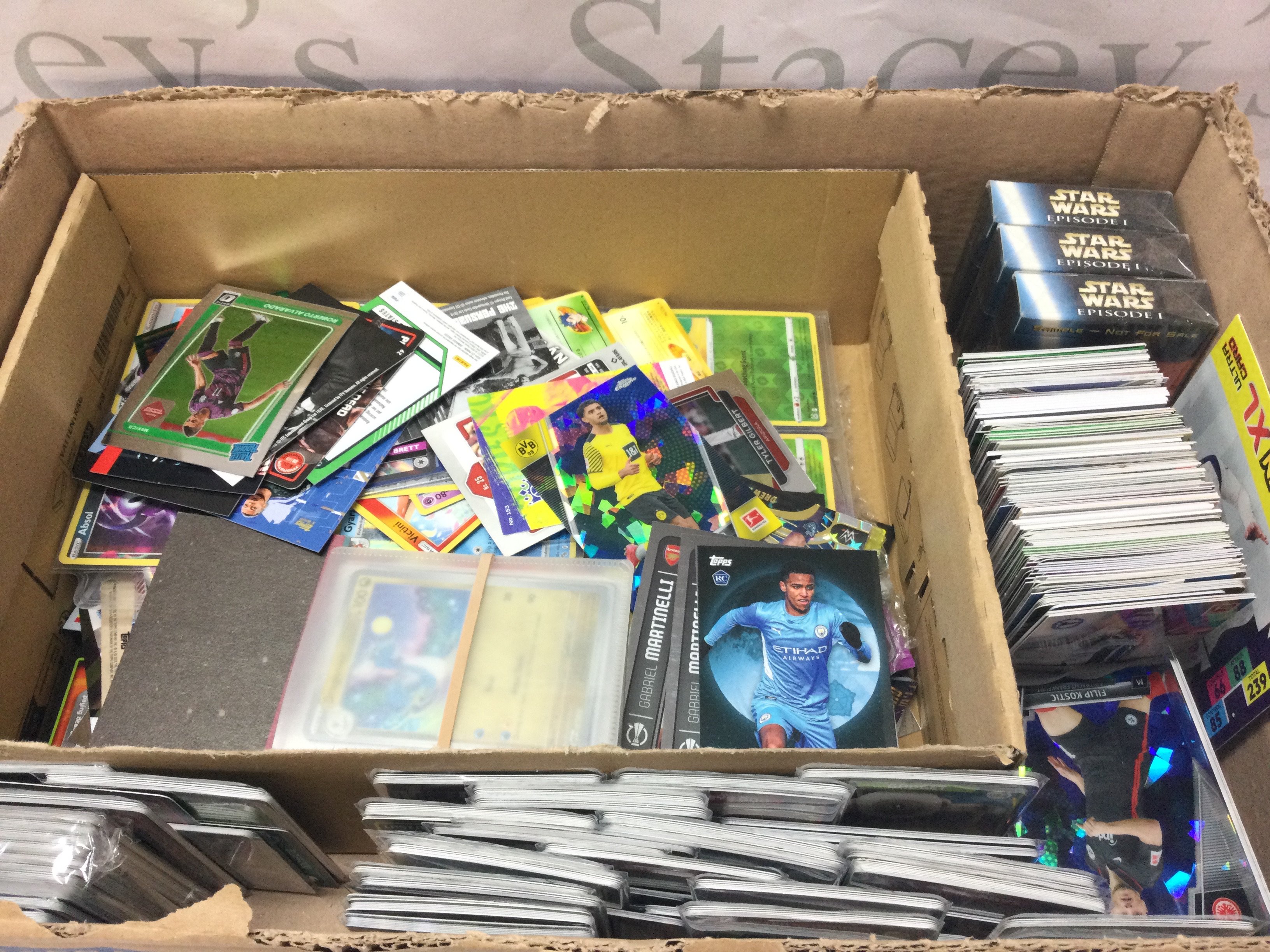 An assortment of trading cards including Pokemon, Topps, Panini , Star Wars , Doctor who etc. postage category C