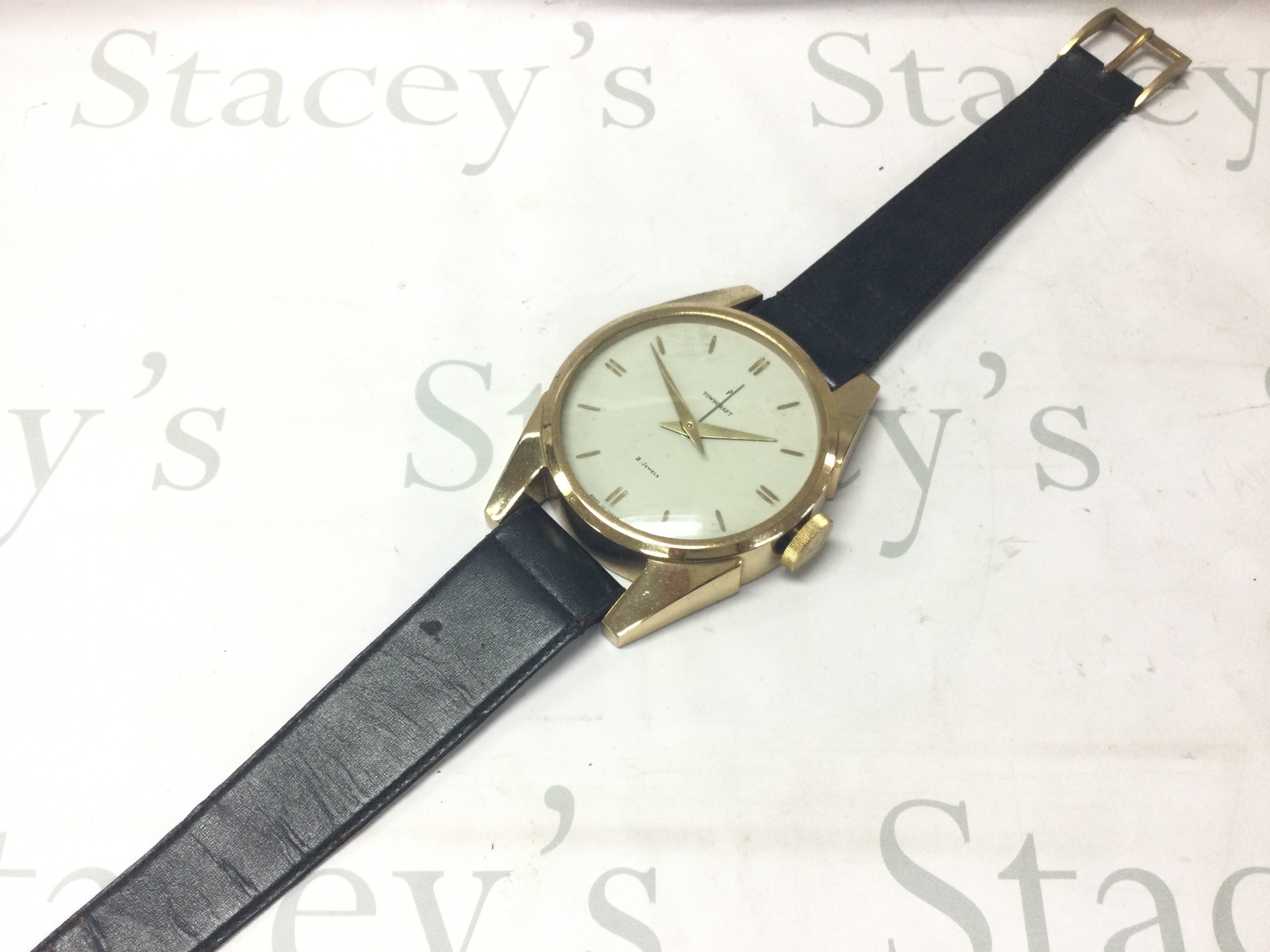 A c1960 towncraft brass and leather wall clock/ watch , 2 jewels , seen working.