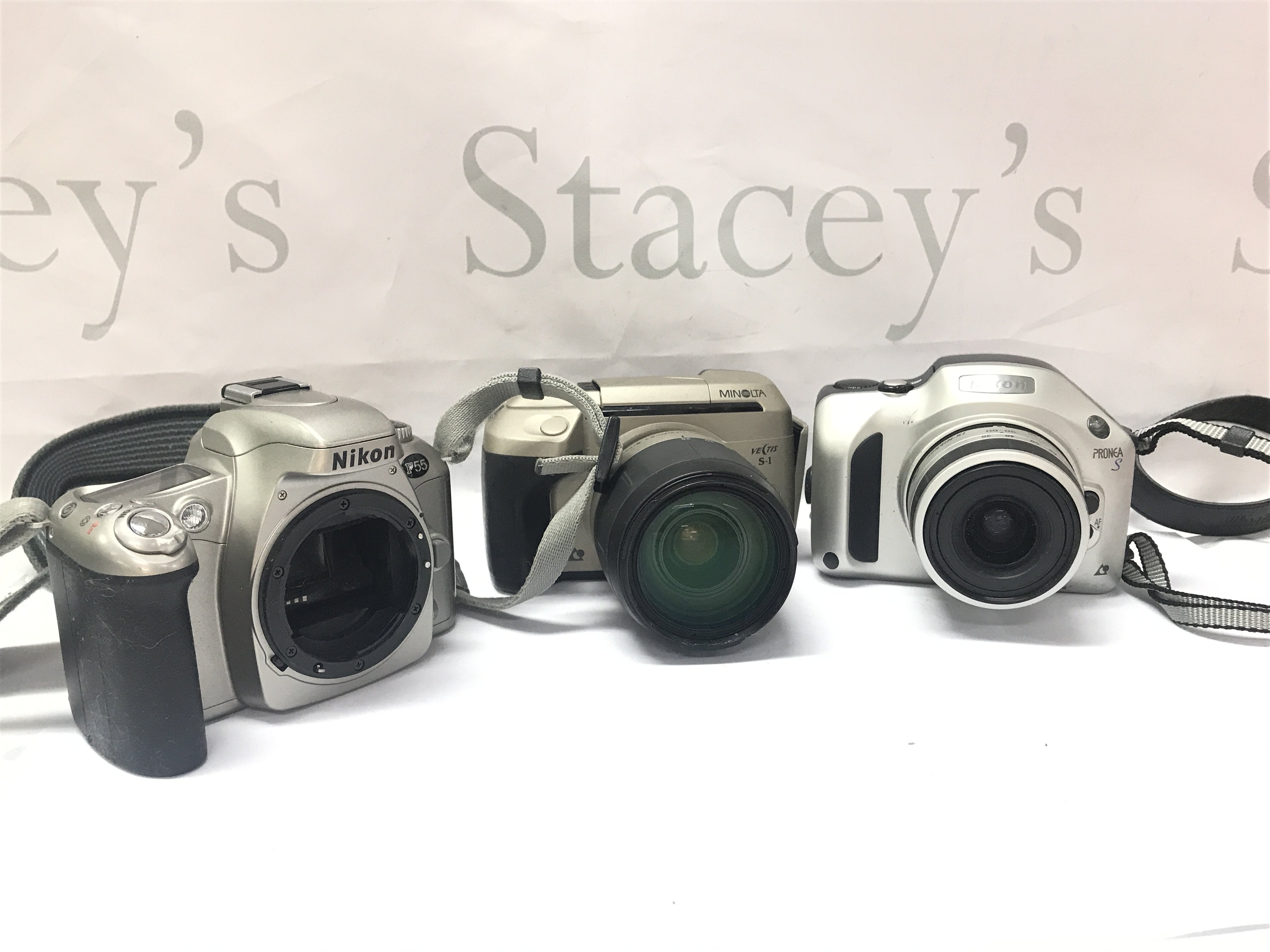 Three vintage cameras, Nikon and Minolta. Postage category B