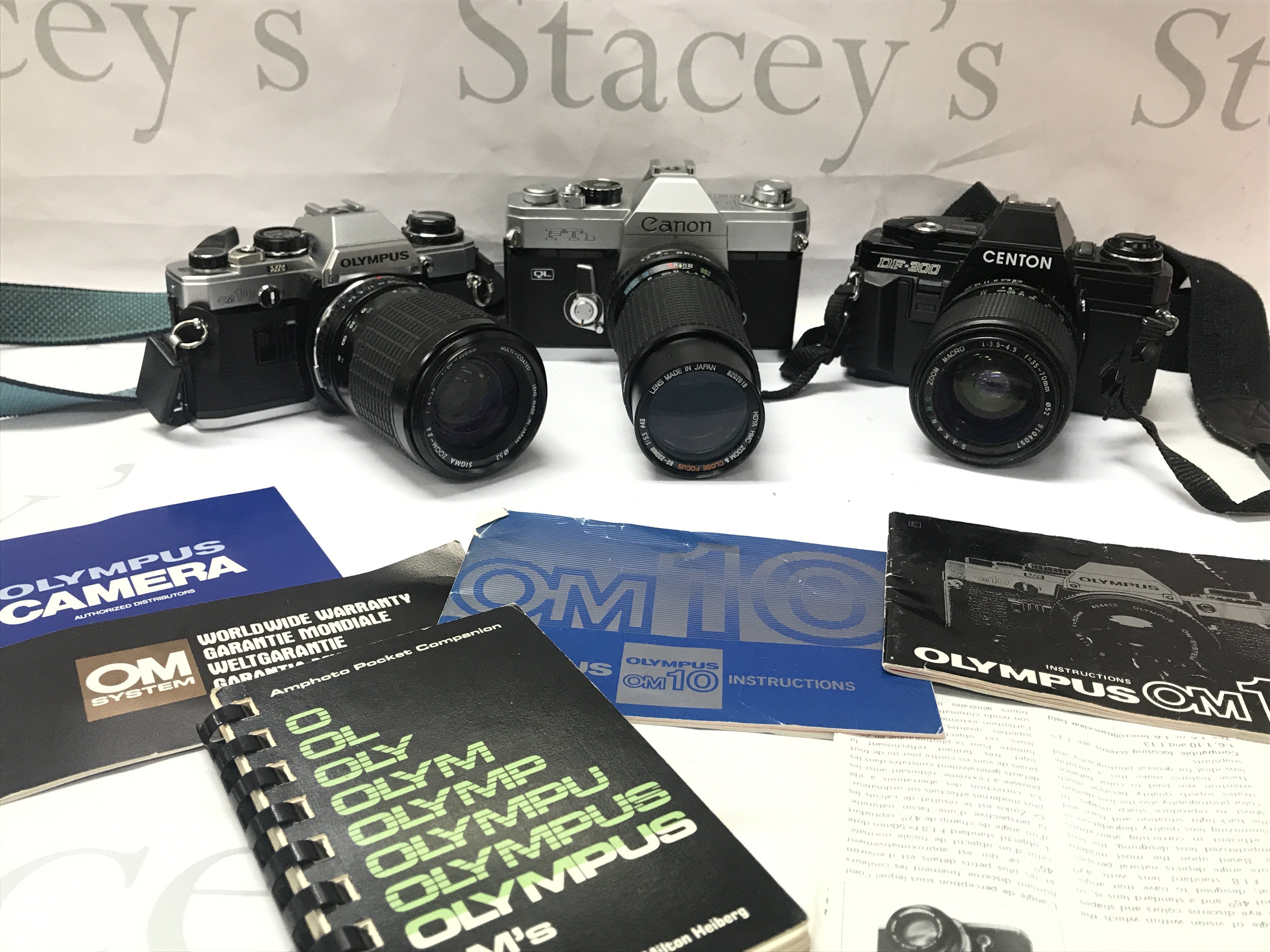 Three vintage SLR cameras, Olympus , Centon. Postage cat C