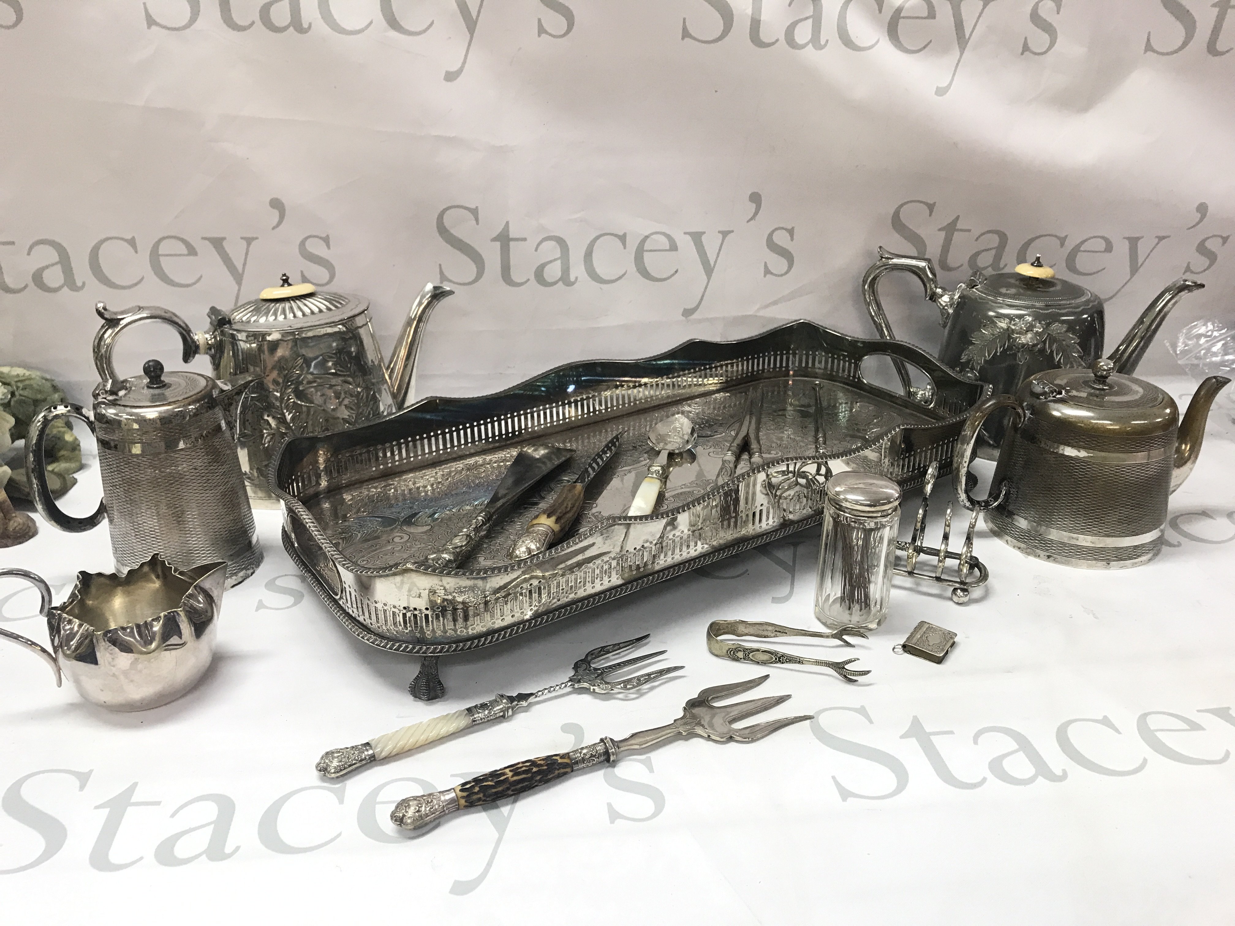 Various silver plated items including a tray, tea jugs, utensils etc . Postage category C
