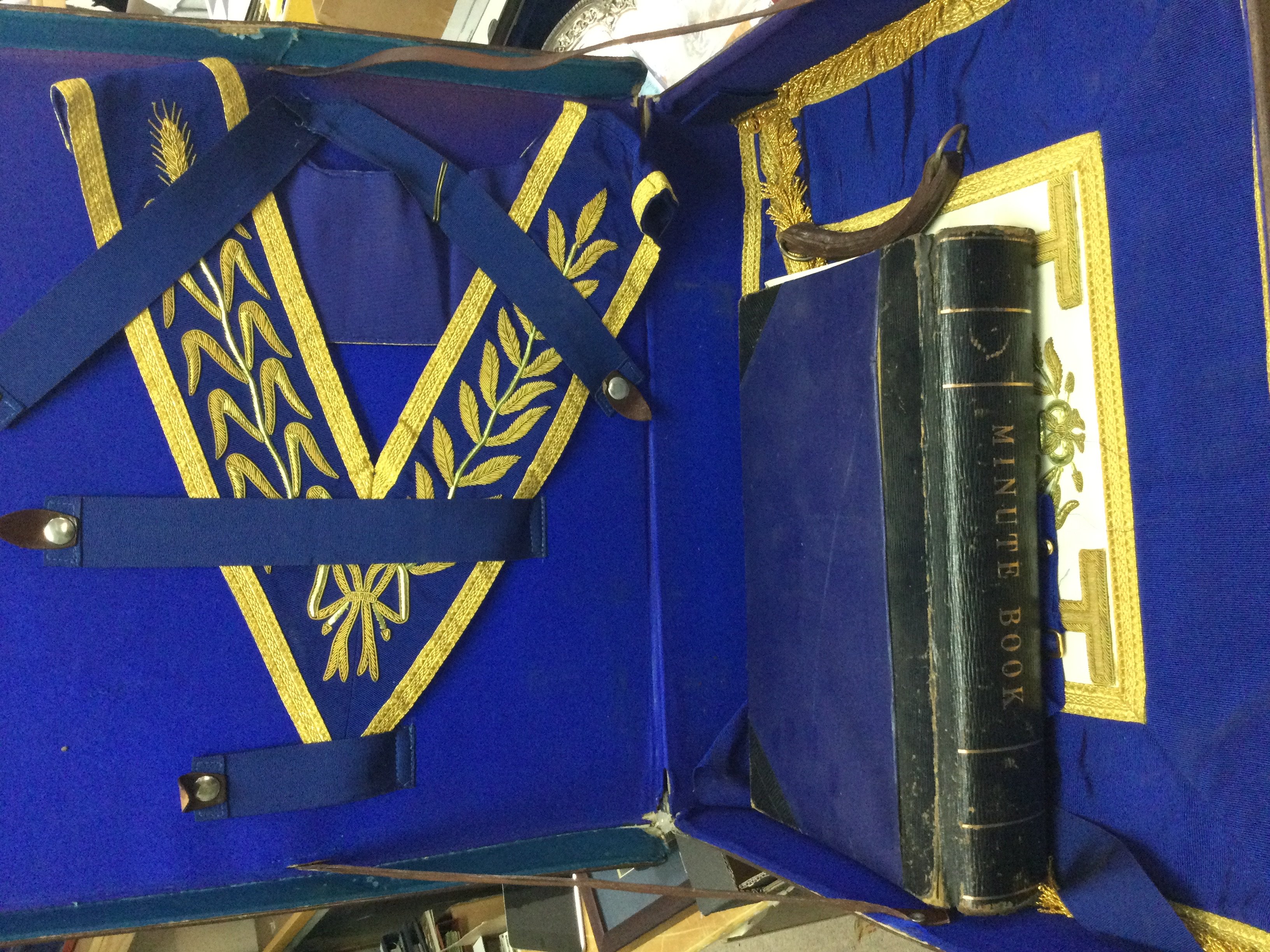 A leather case containing Masonic items including a Minute book. This lot cannot be posted