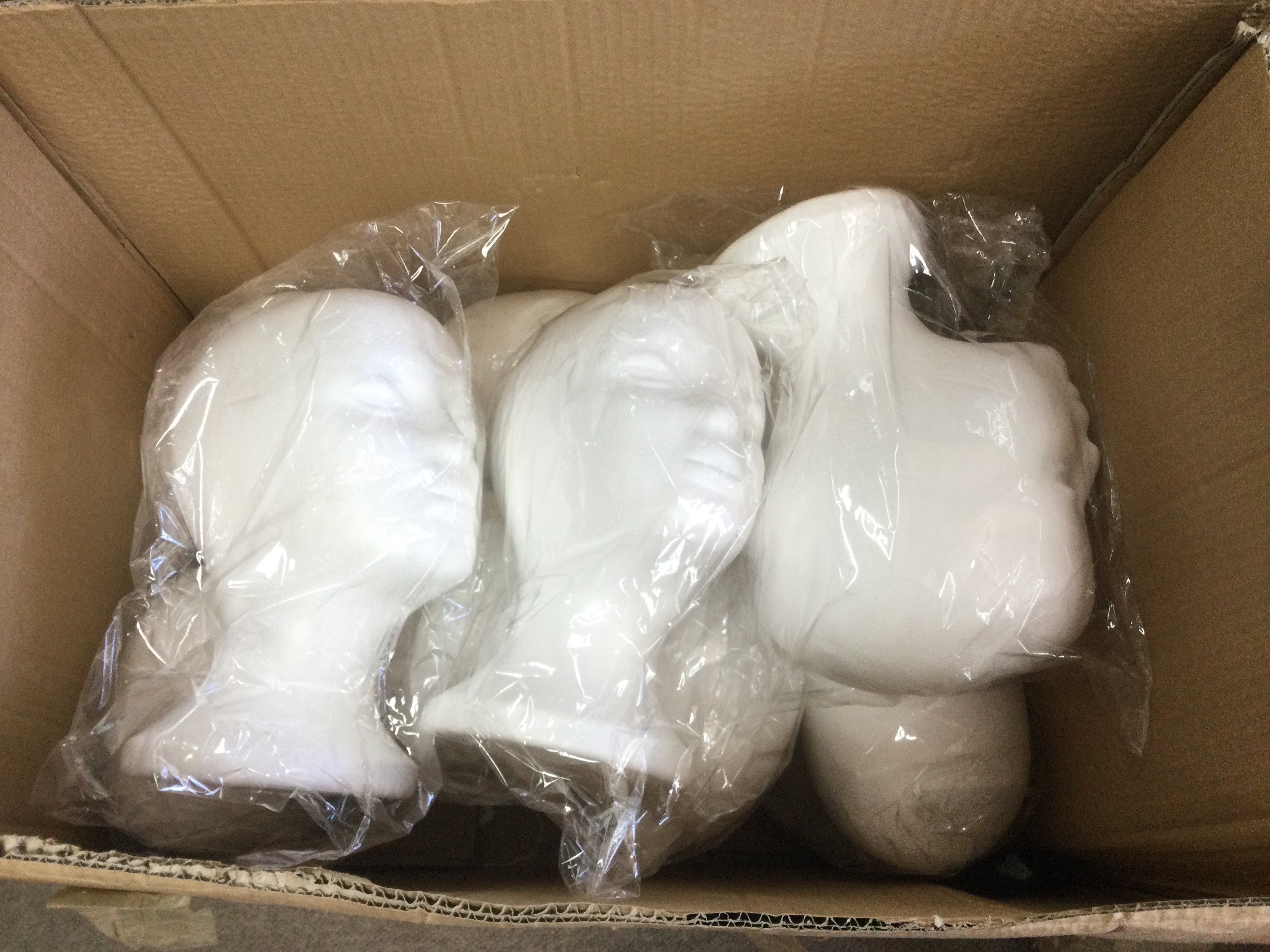 Ten polystyrene mannequin heads. Shipping category C.