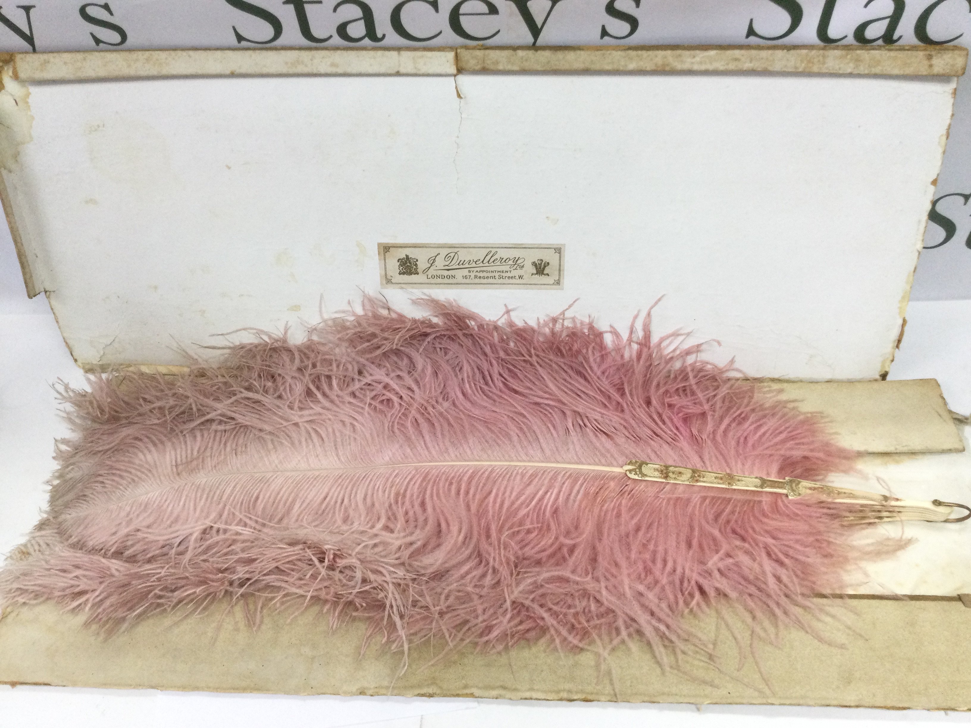 A vintage feather fan. Shipping category C.