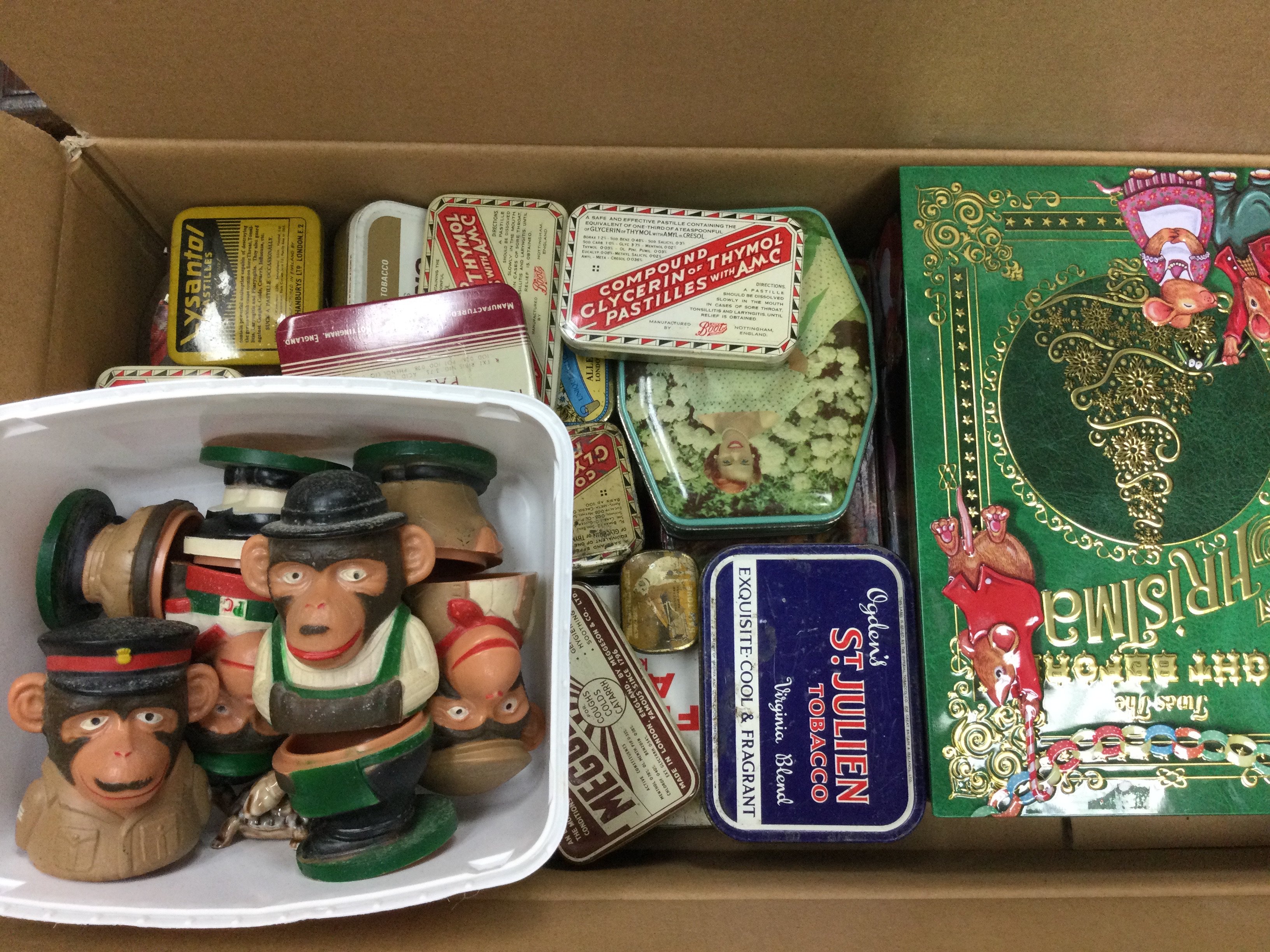 Two boxes containing various tins including OXO, Colmans Mustard etc, together with PG Tips Monkey Egg Cups