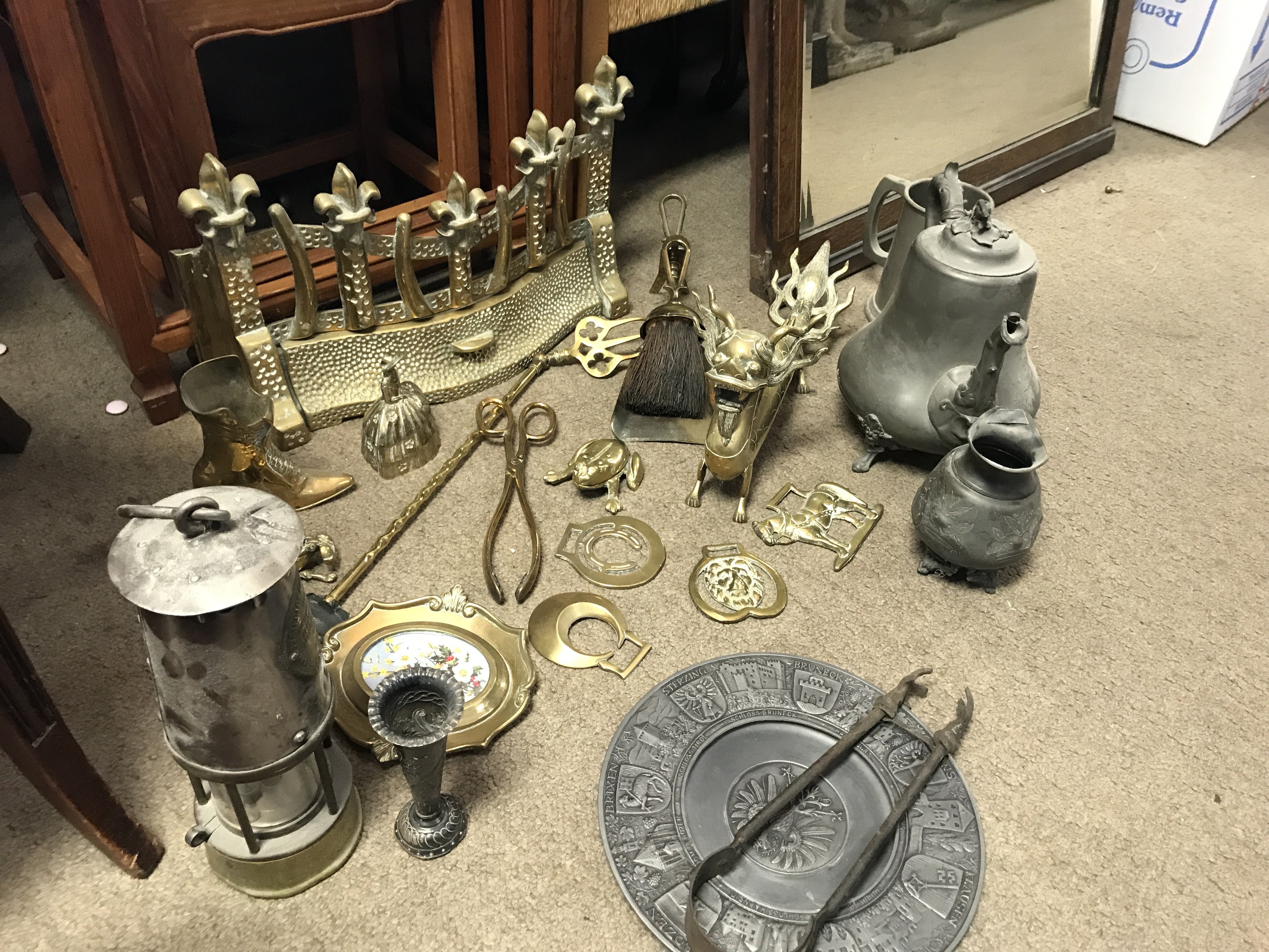 A miners Lamp and brassware including a dragon figure, fireplace grate etc