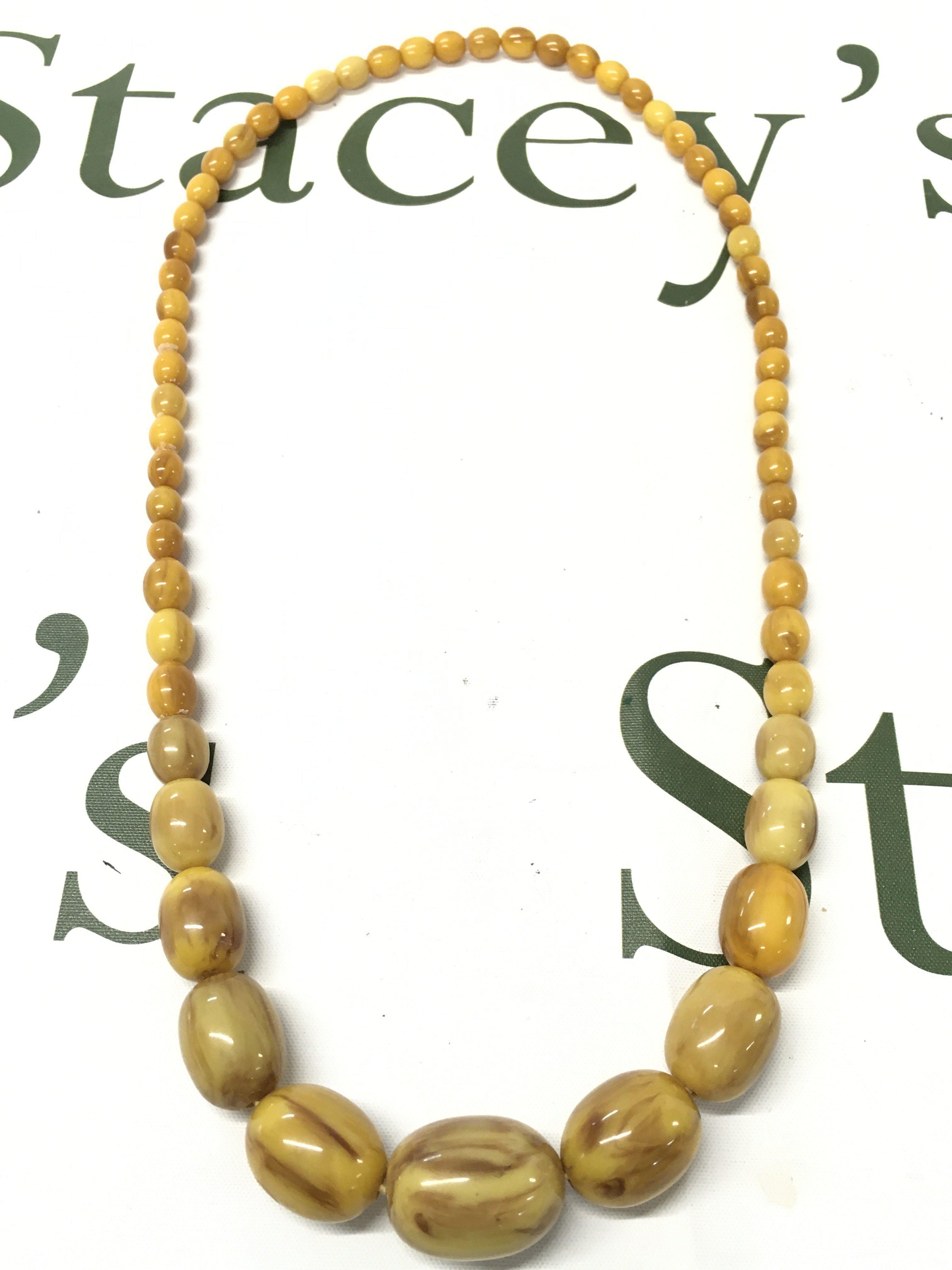 A Butterscotch Bakelite amber necklace  70cm, 70g total weight. Postage category A