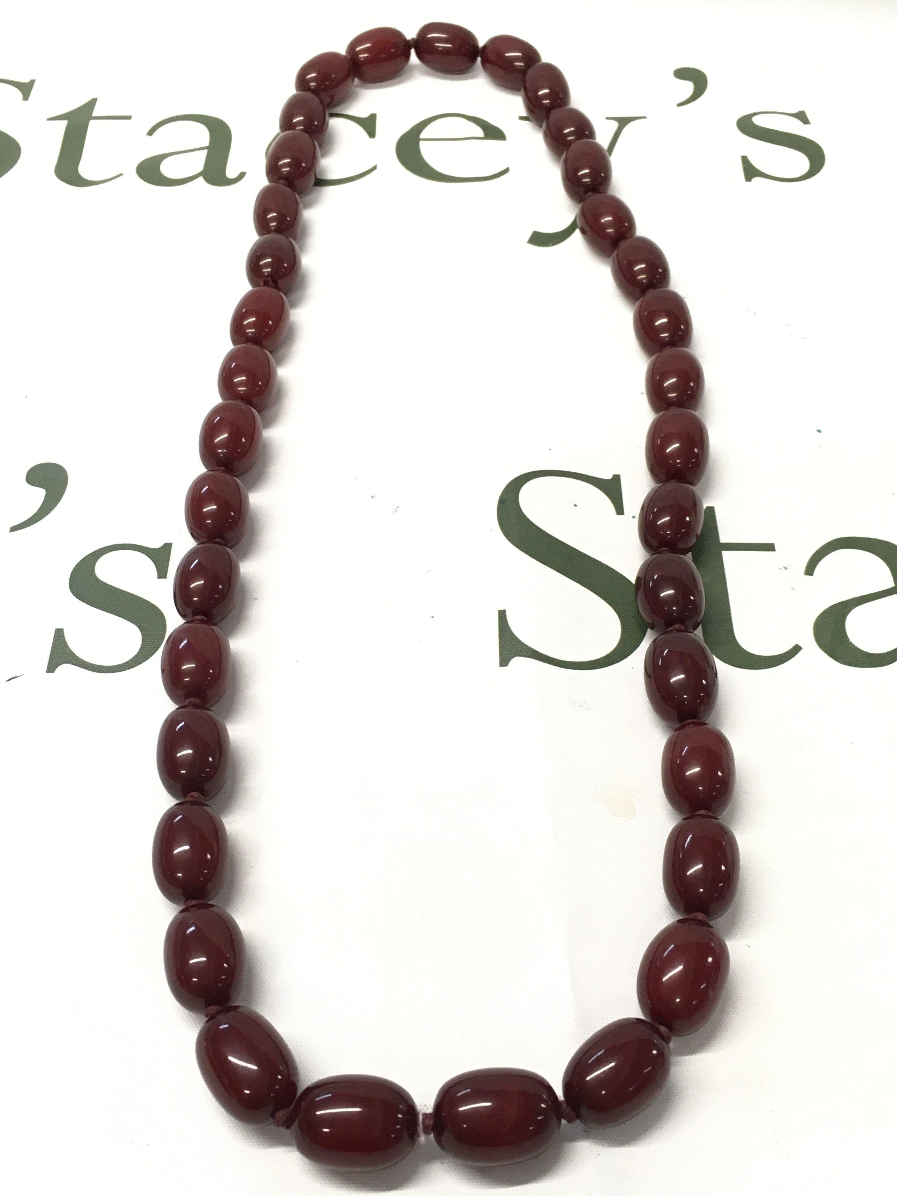 Cherry amber bakelite necklace, 84cm long . 135g total weight. Postage category A