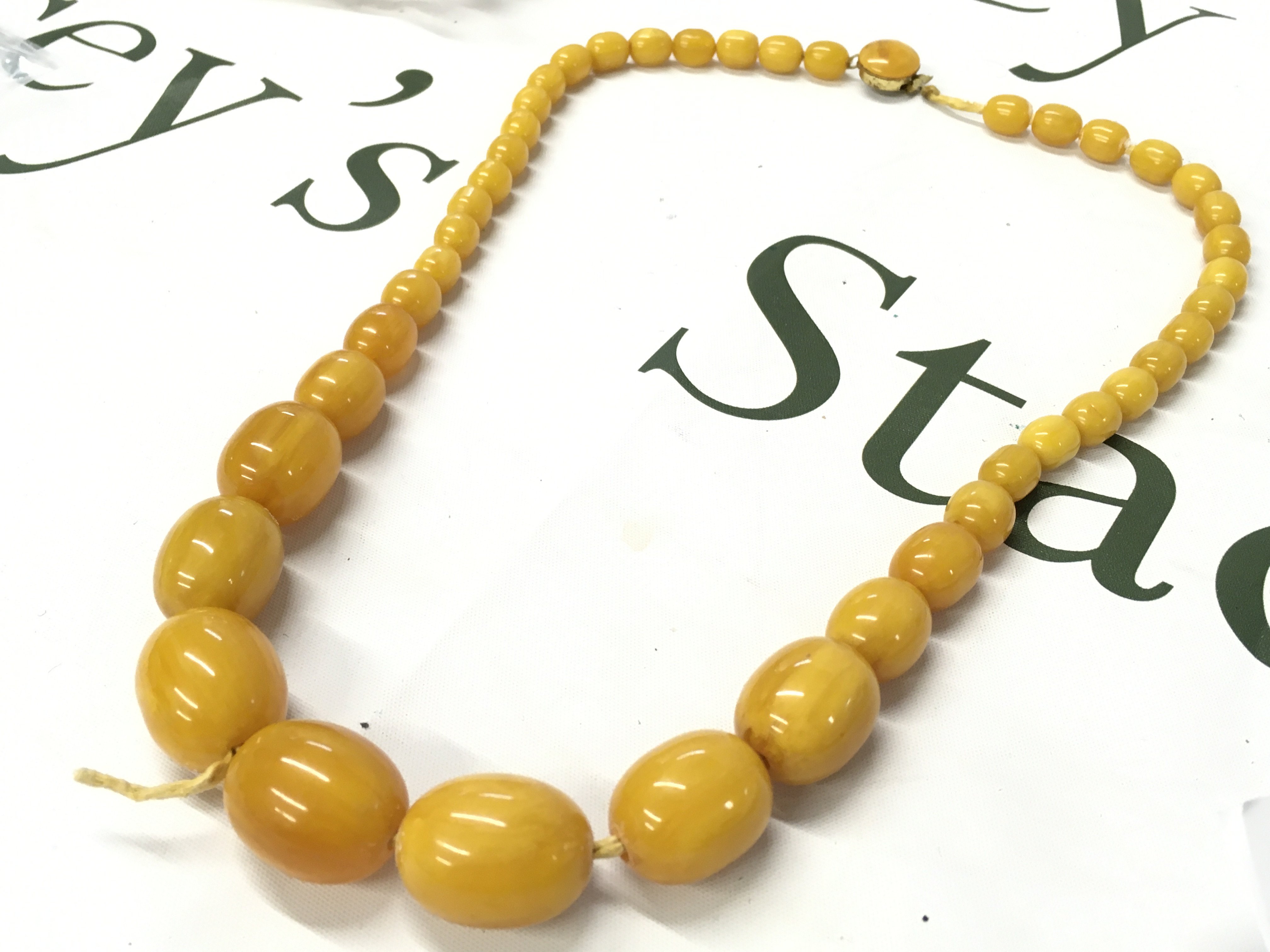 Butterscotch bakelite amber necklace , 70cm long 95g total weight. Postage category A