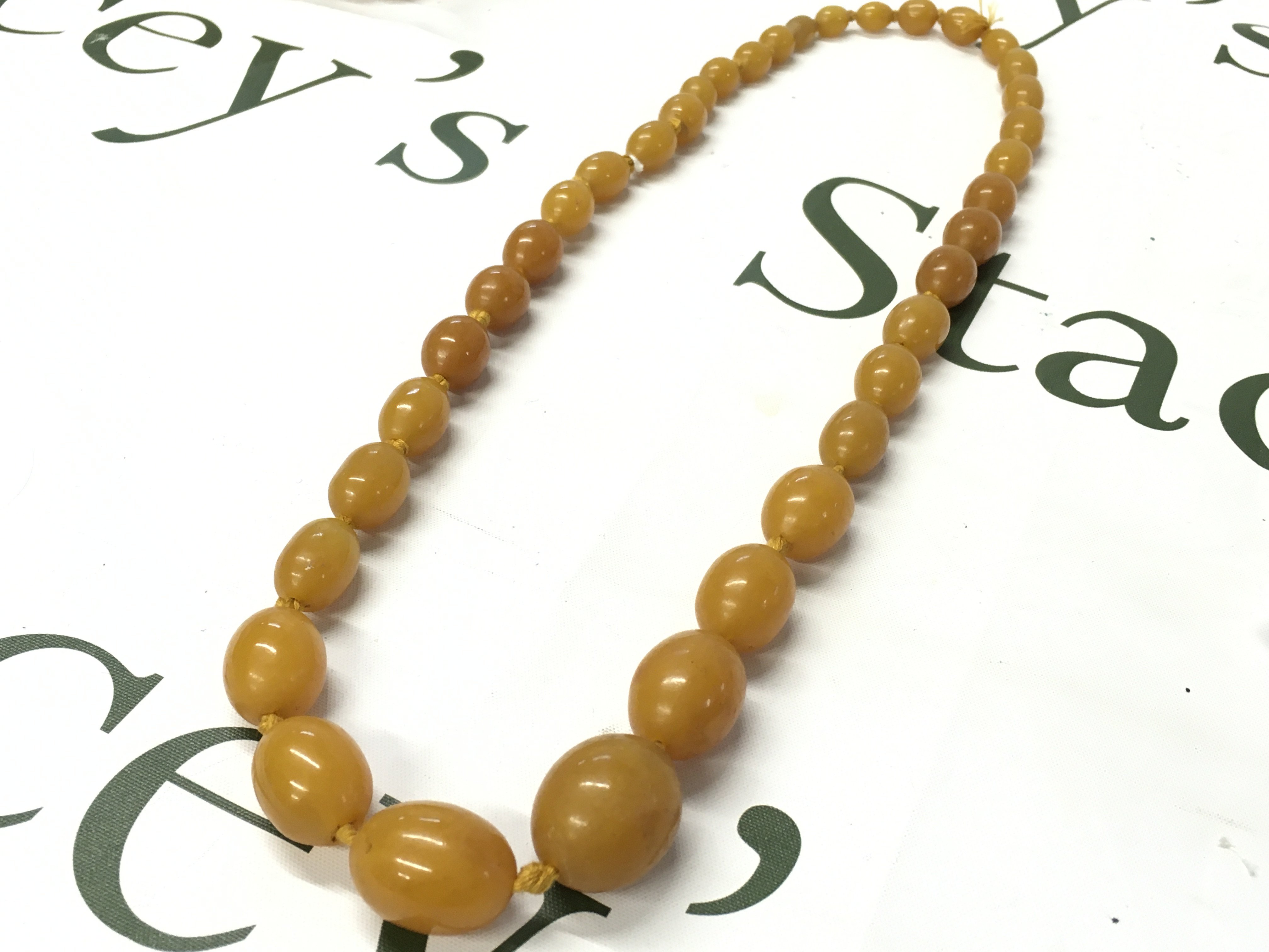 Butterscotch bakelite amber necklace , 74cm and 100g total weight postage category A