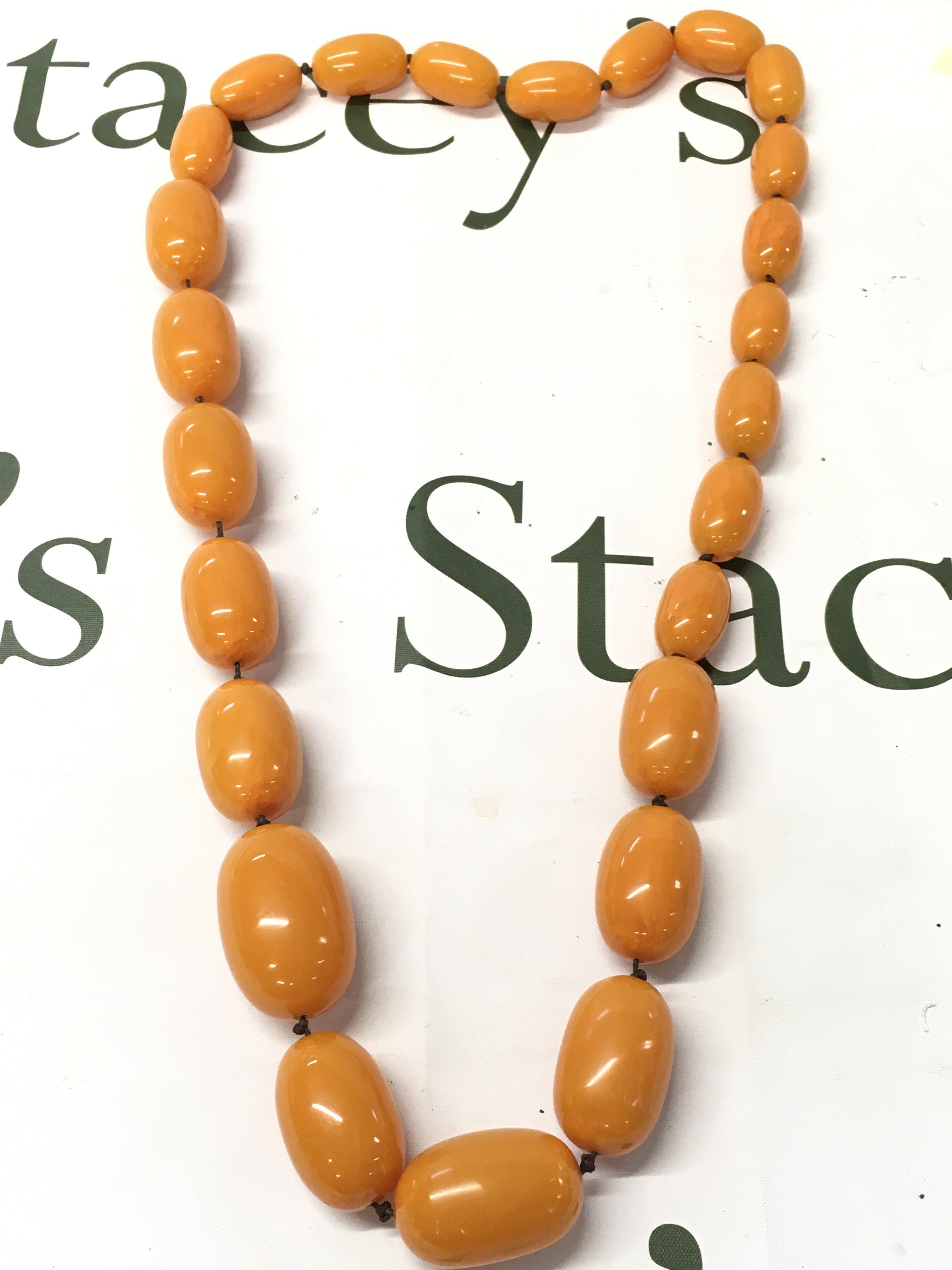 Large bakelite amber necklace , 94cm long , 290g total weight. Postage category A