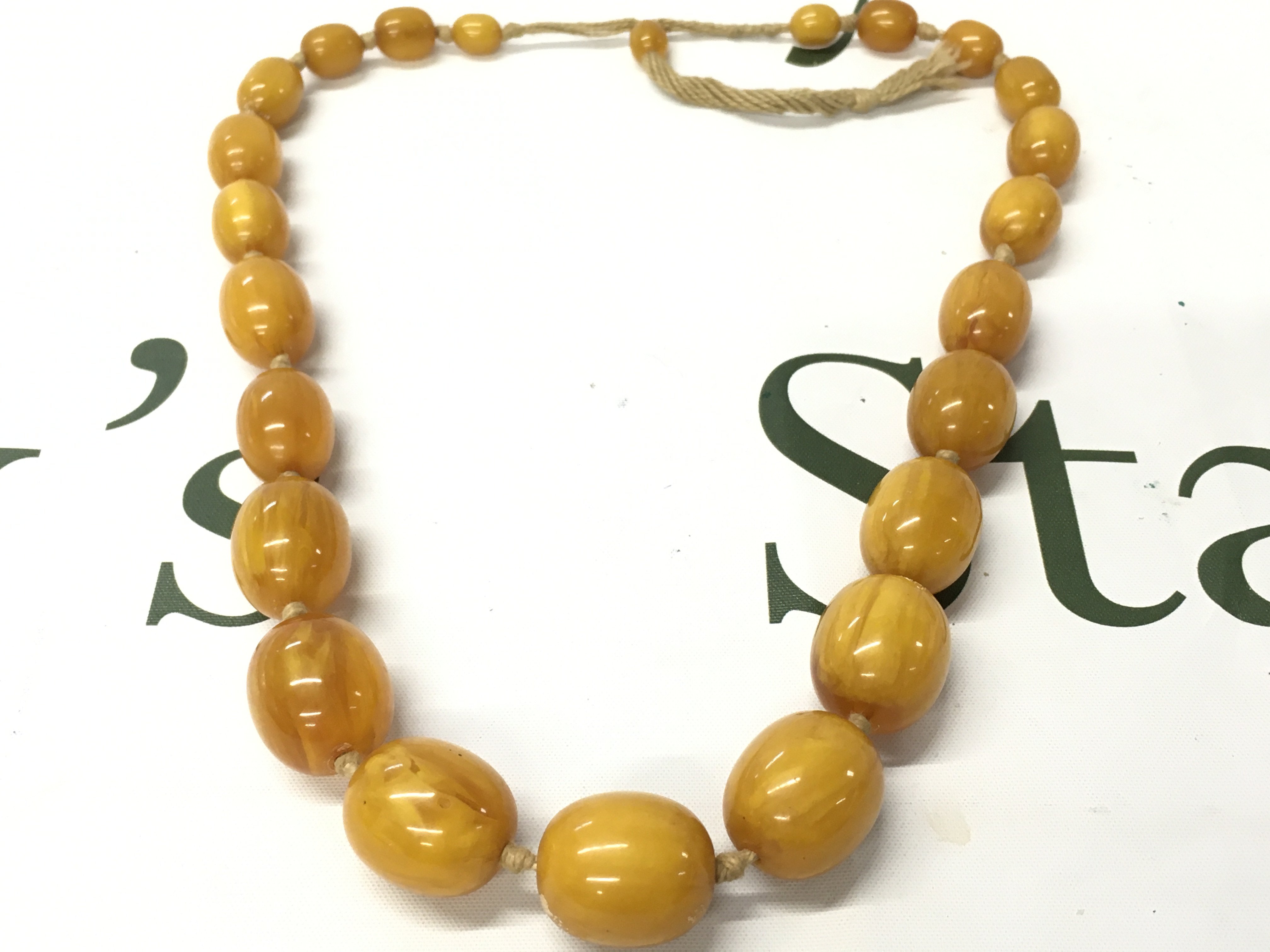 A butterscotch bakelite amber necklace , 105g total weight 62cm long. Postage catA