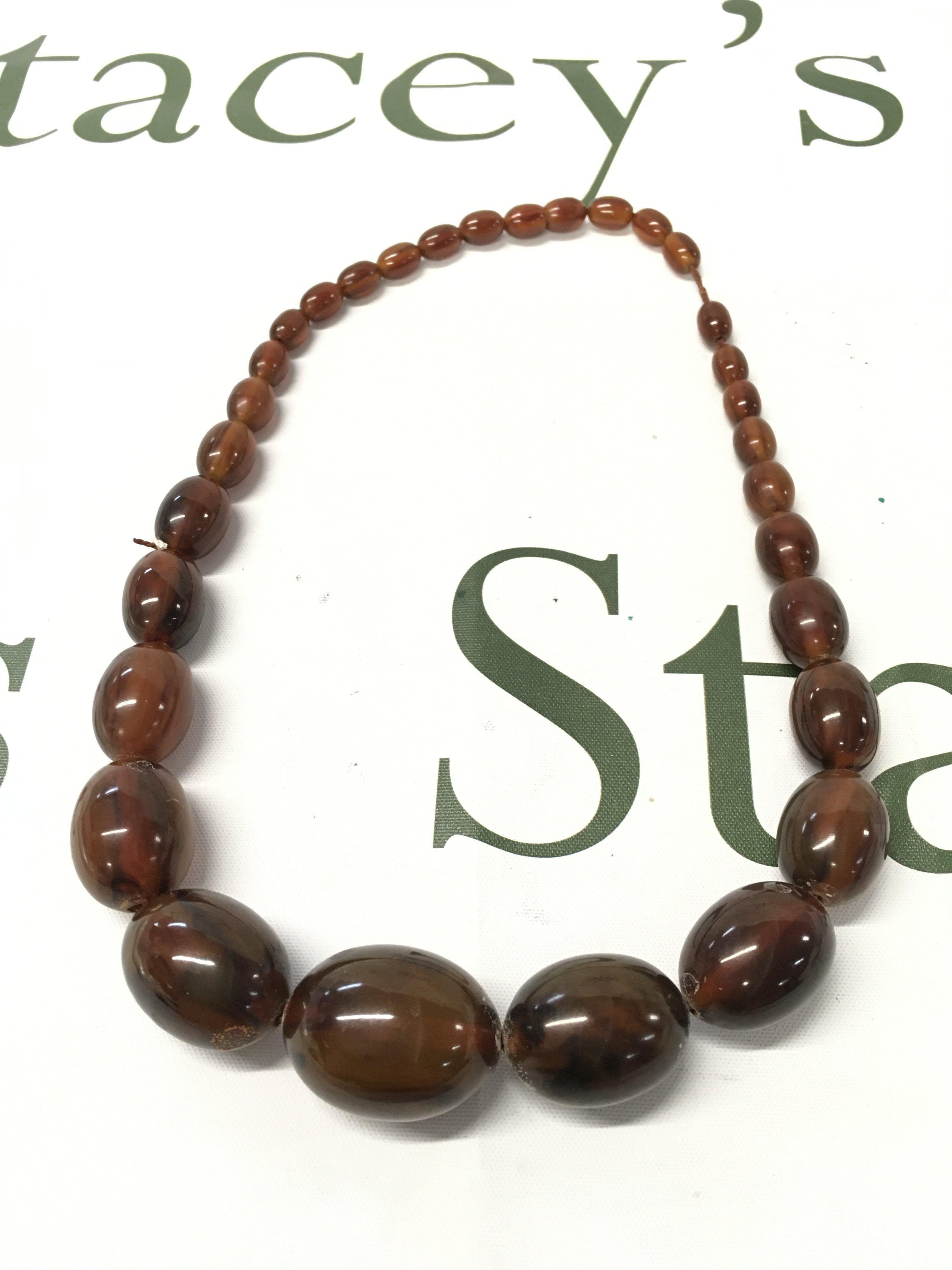 A bakelite amber necklace , 52cm long 80g Approx total weight. Postage cat A