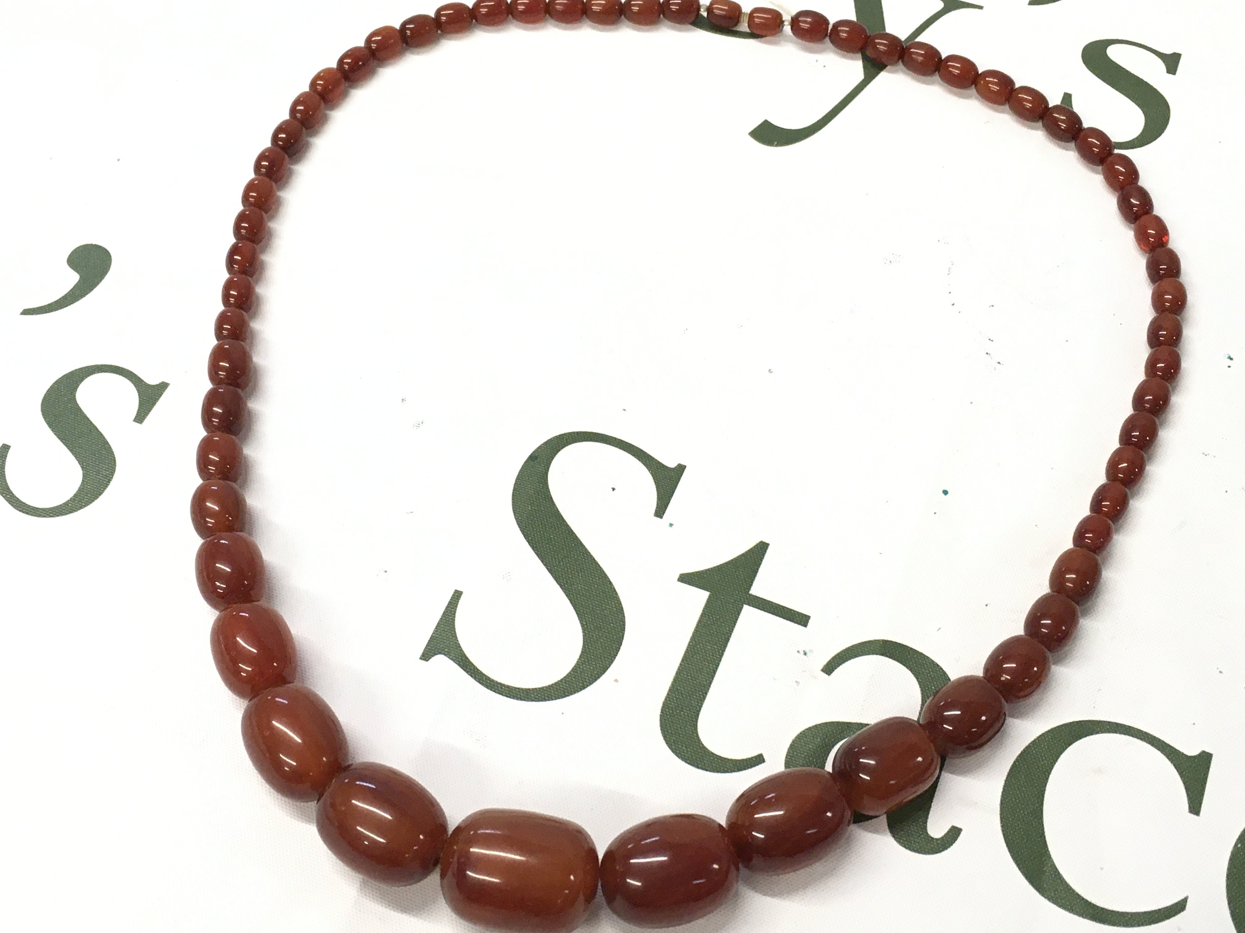 A bakelite cherry amber necklace, 70cm long . 70g total weight postage cat A