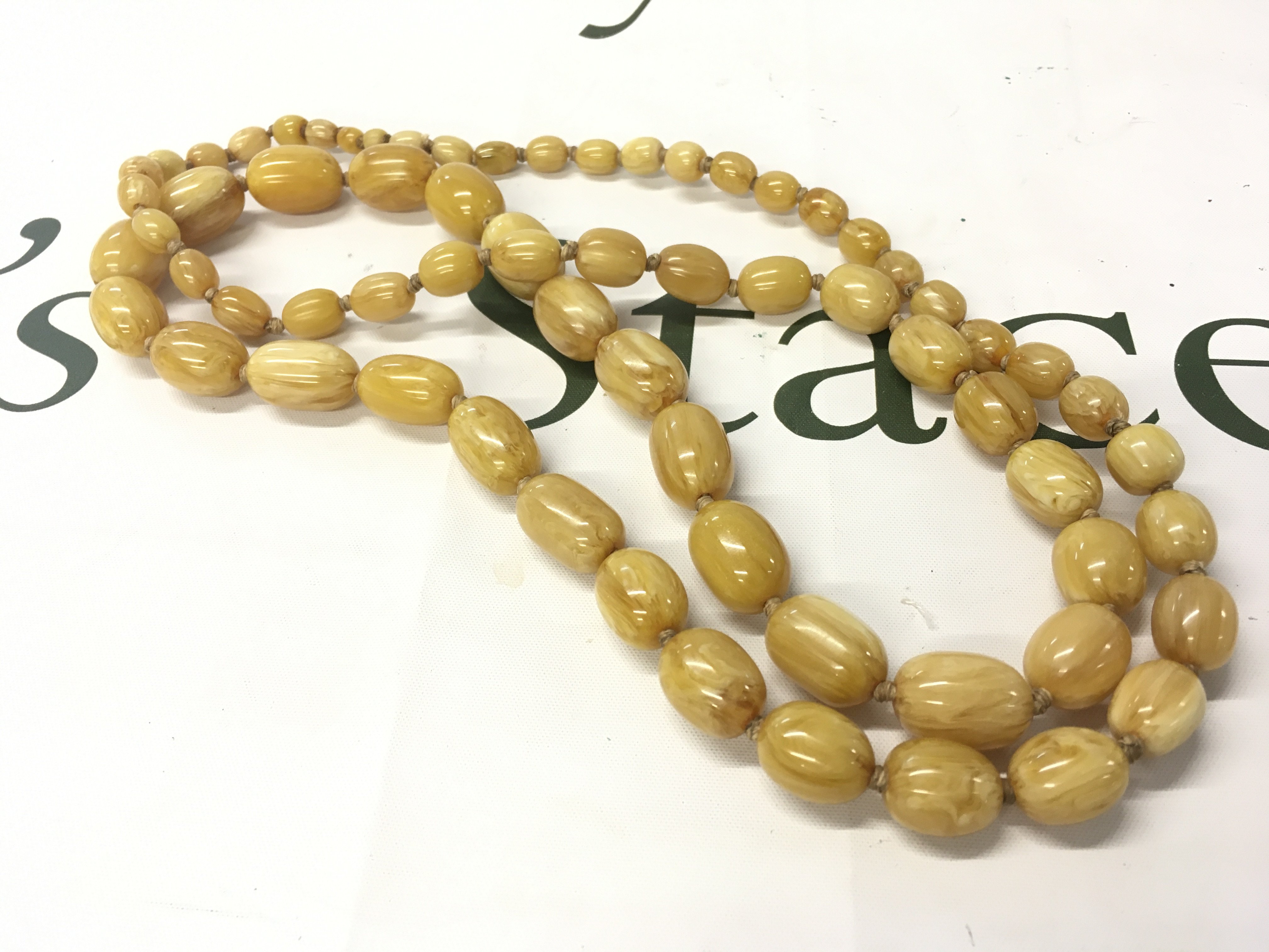 A butterscotch bakelite amber necklace , 120cm and 146g Approx weight Postage category A