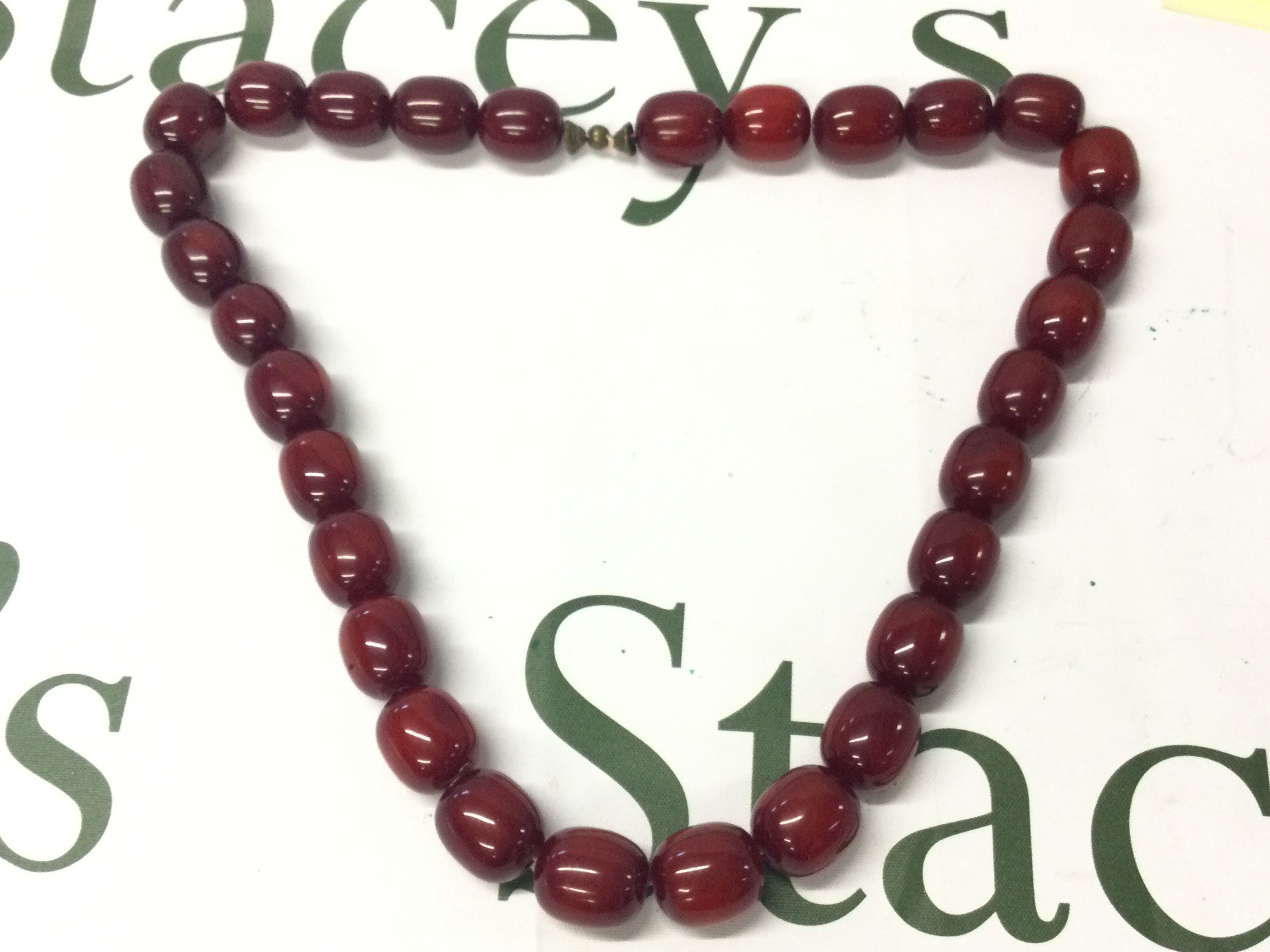 A cherry amber Bakelite necklace , 145g total approx weight. 67cm total length. postage category A
