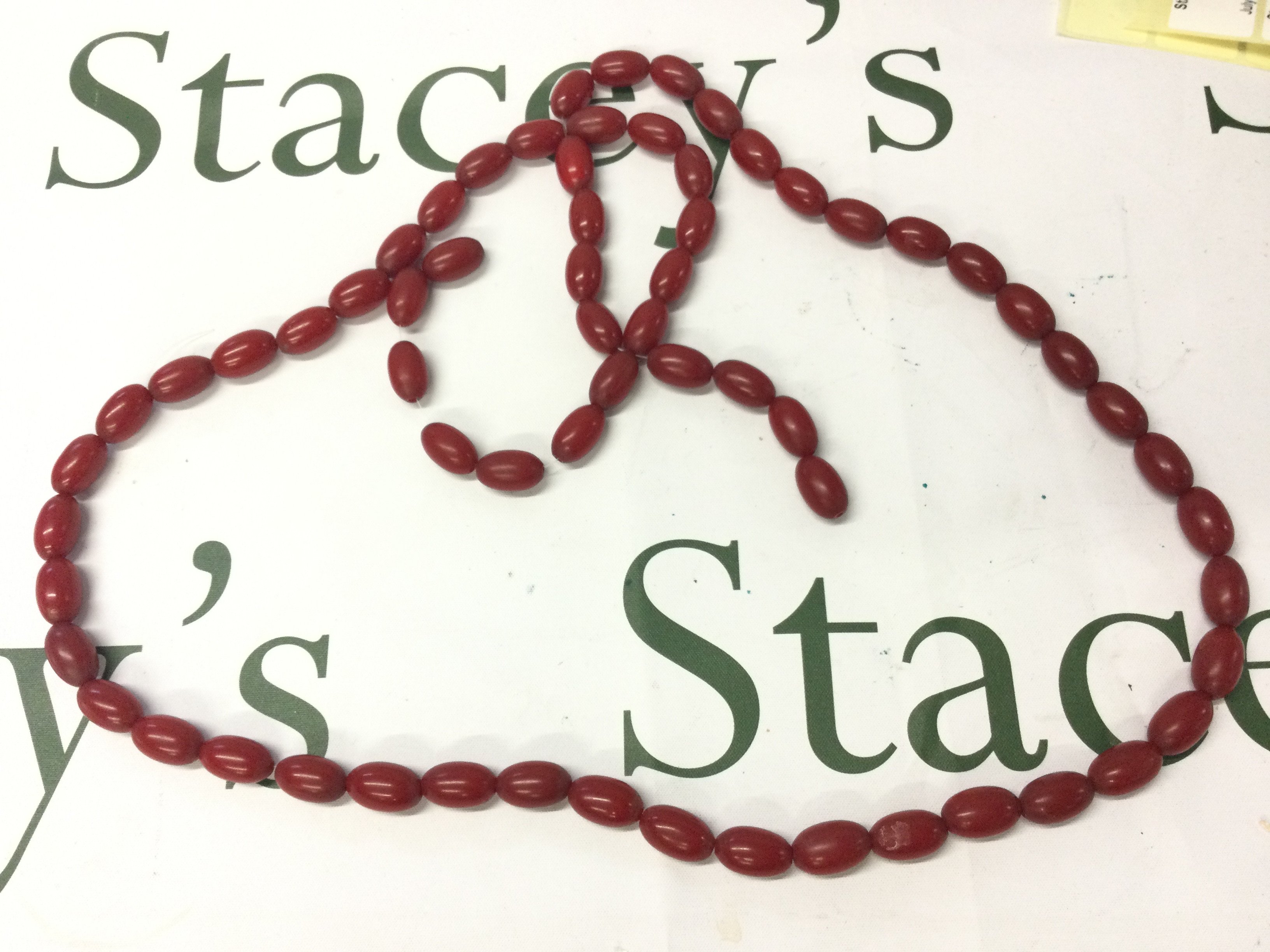 A Bakelite cherry coloured necklace 120cm long 120g , postage category A