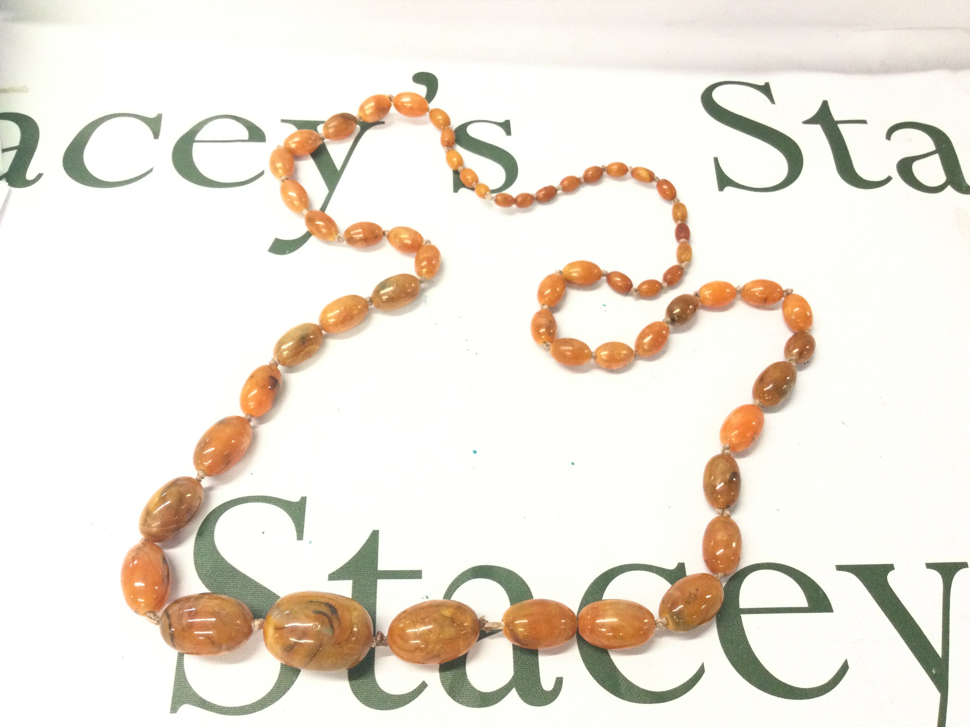 A Graduated Baltic Amber Necklace, 90cm and 60g weight